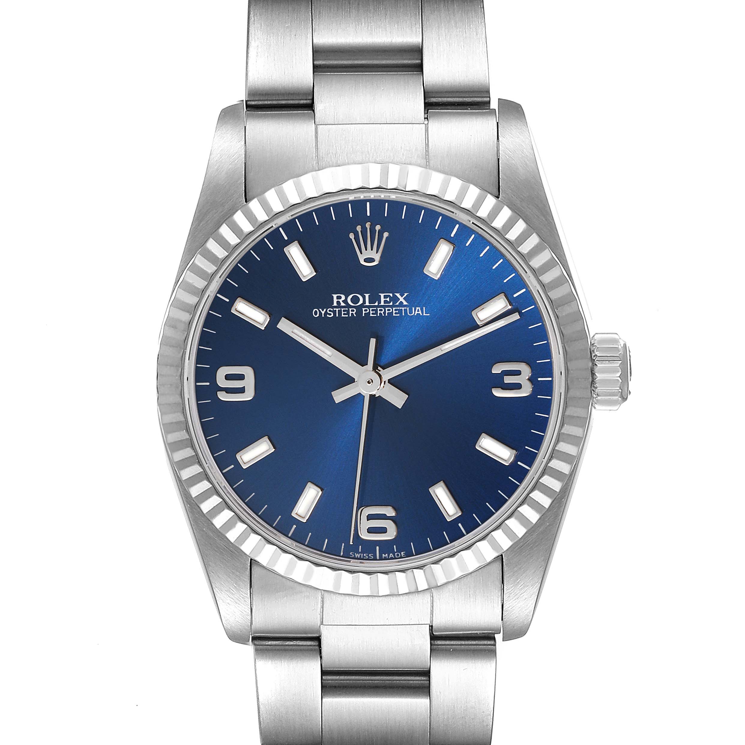 The image shows a front view of a Rolex Oyster Perpetual Mid-Size model with a blue dial and stainless steel bracelet.