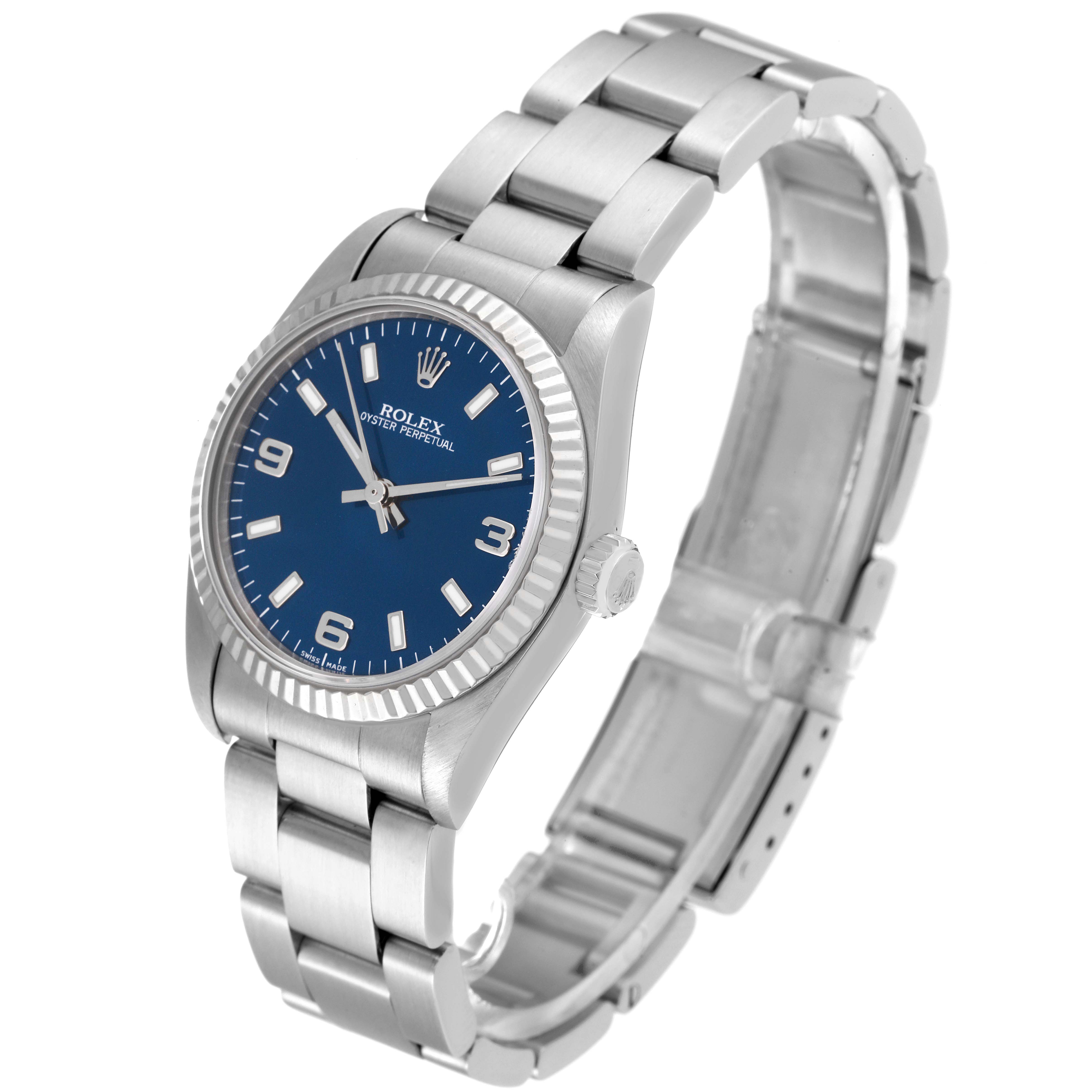 This image shows a Rolex Mid-Size 67514 Women
s Stainless Steel Blue Dial 67514 Women
s Stainless Steel Blue Dial Oyster Perpetual watch at an angled side view, highlighting the dial, case, and bracelet.