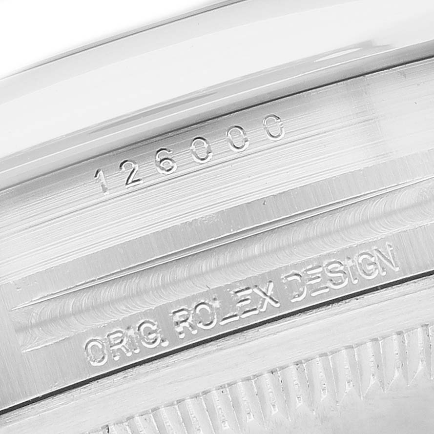 The image shows the serial and design engravings on the side of the Rolex Oyster Perpetual 126000 Men's Stainless Steel Silver Dial model.