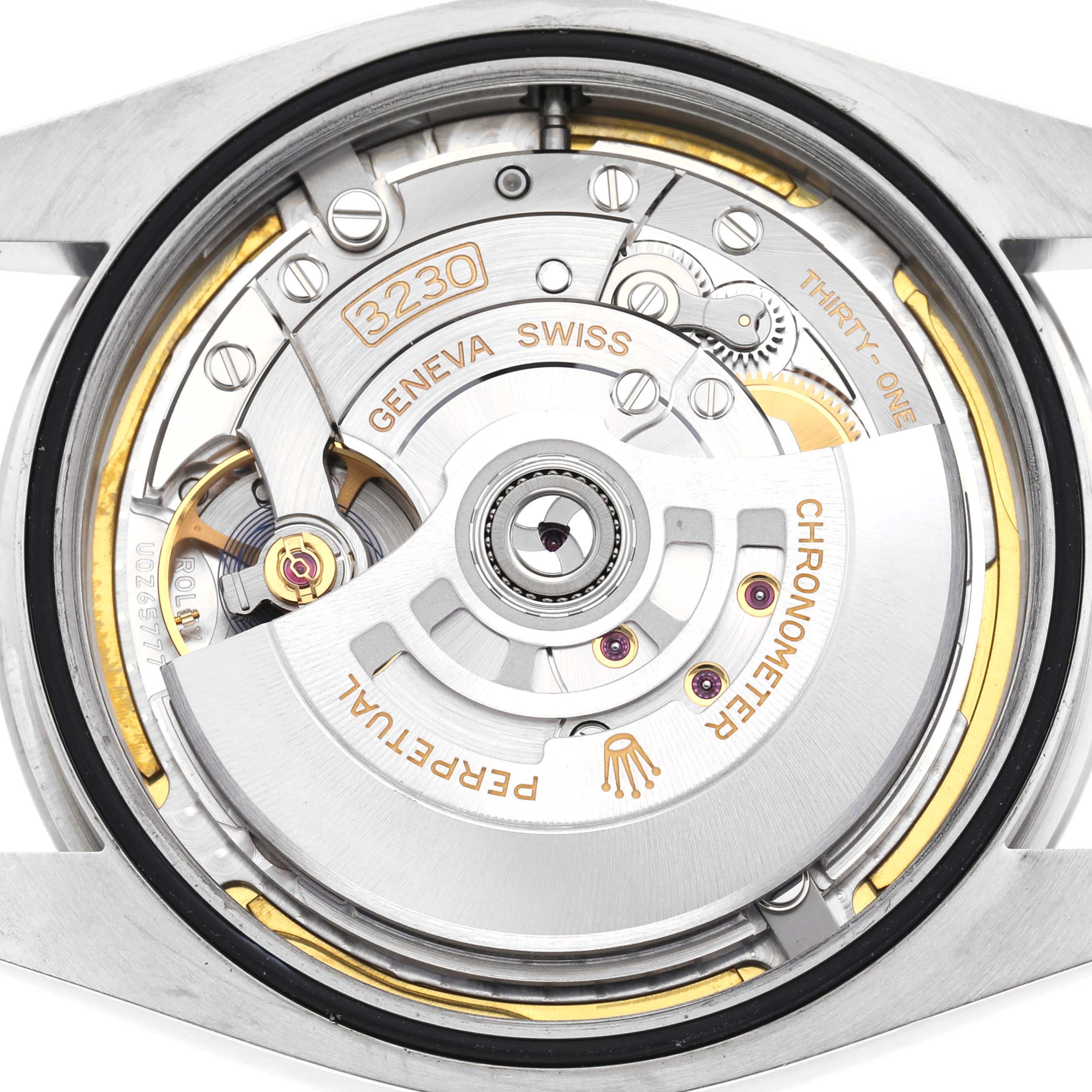 The image shows the movement of a Rolex Oyster Perpetual 124300 Men
s Stainless Steel Green Dial 124300 Men
s Stainless Steel Green Dial watch from the back, highlighting the inner mechanics and rotor.