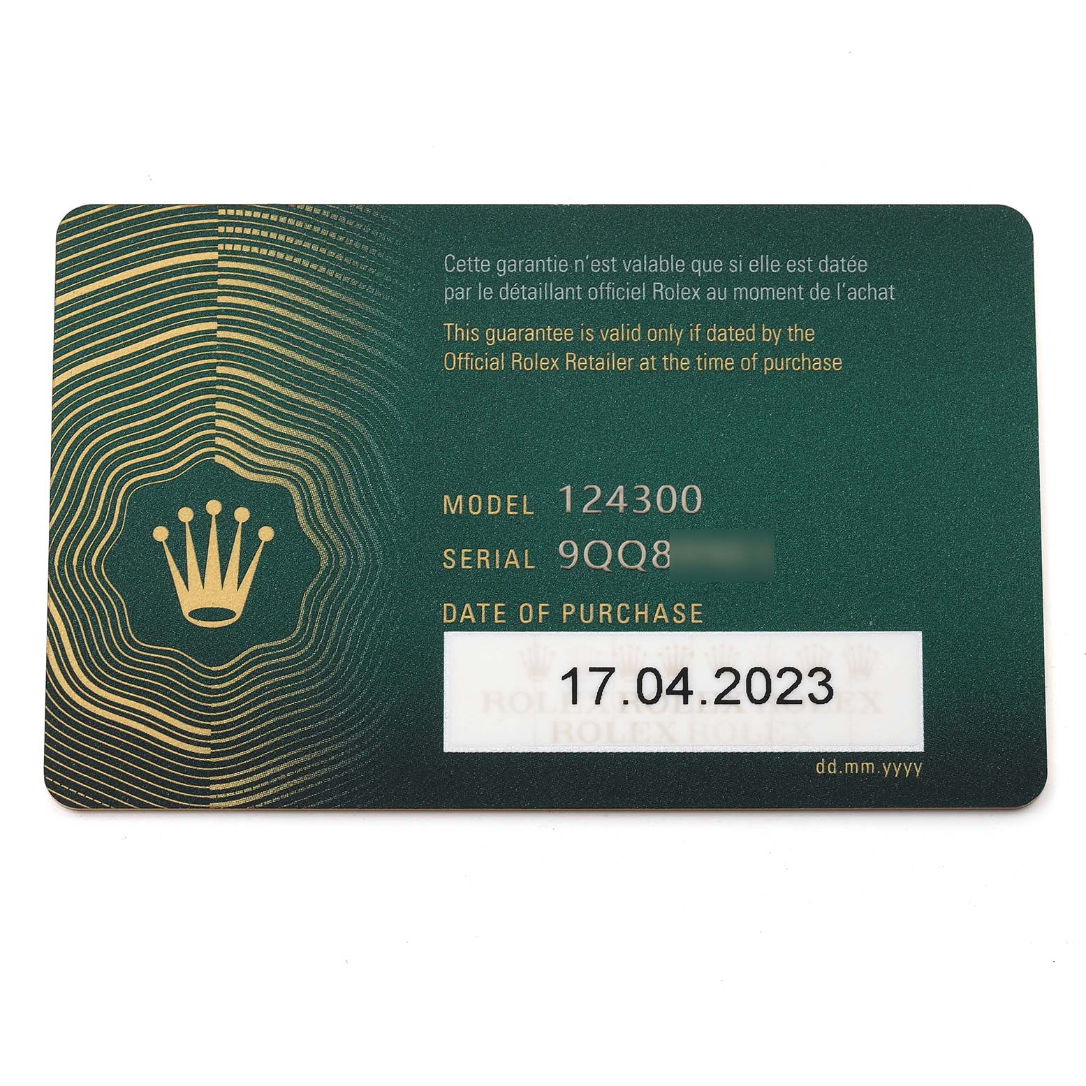 This image shows a green warranty card for a Rolex Oyster Perpetual 124300 Men's Stainless Steel Black Dial 124300 Men's Stainless Steel Black Dial model 124300, including the serial number and date of purchase.