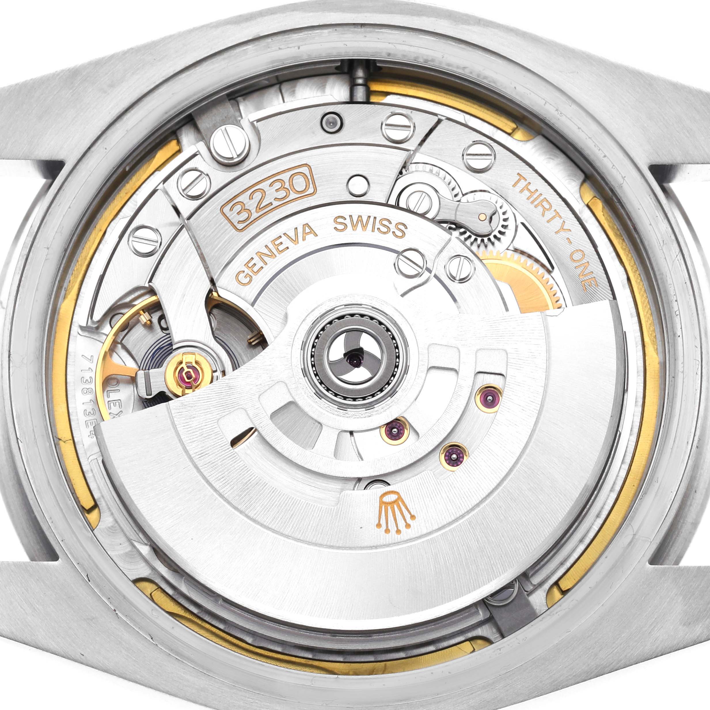 The image shows a close-up of the movement of a Rolex Oyster Perpetual 124300 Men
s Stainless Steel Yellow Dial 124300 Men
s Stainless Steel Yellow Dial watch, highlighting the intricate mechanisms and engravings.