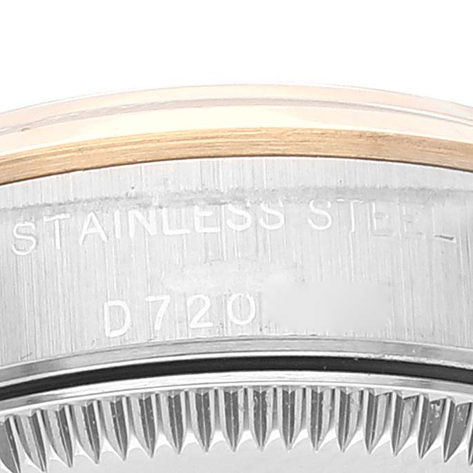 This image shows a close-up view of the case back edge and serial number of a Rolex Oyster Perpetual 76183 Women
s Steel and Gold (two tone) Grey Dial 76183 Women
s Steel and Gold (two tone) Grey Dial watch.
