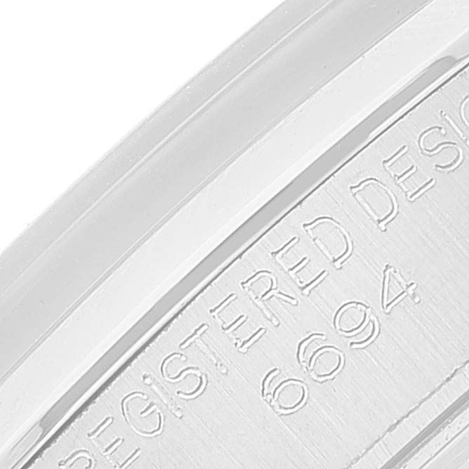 The close-up image shows the edge of the caseback of a Rolex Vintage Collection 6694 Men's Stainless Steel Silver Dial 6694 Men's Stainless Steel Silver Dial watch, revealing part of its engraved text and reference number.