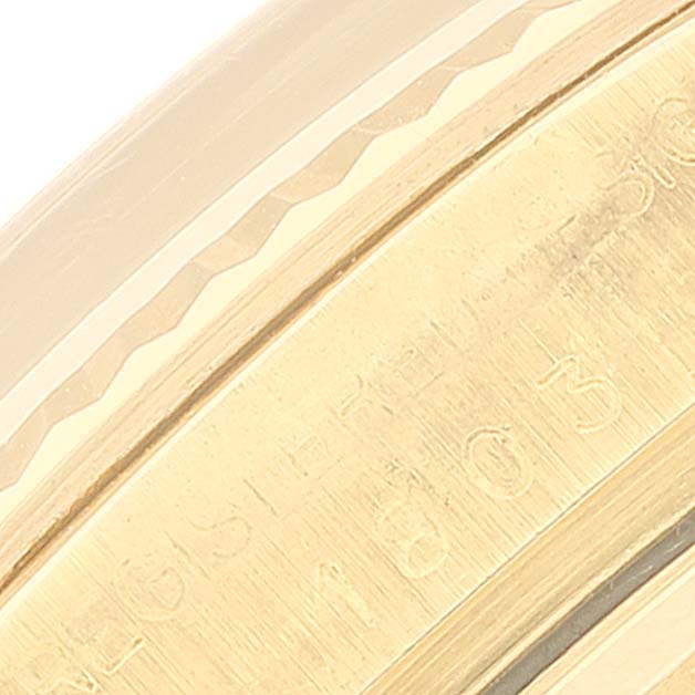 This is a close-up angle of the bezel and part of the case of a Rolex President 1803 Men's Yellow Gold Champagne Dial 1803 Men's Yellow Gold Champagne Dial model watch, showing engraving details.