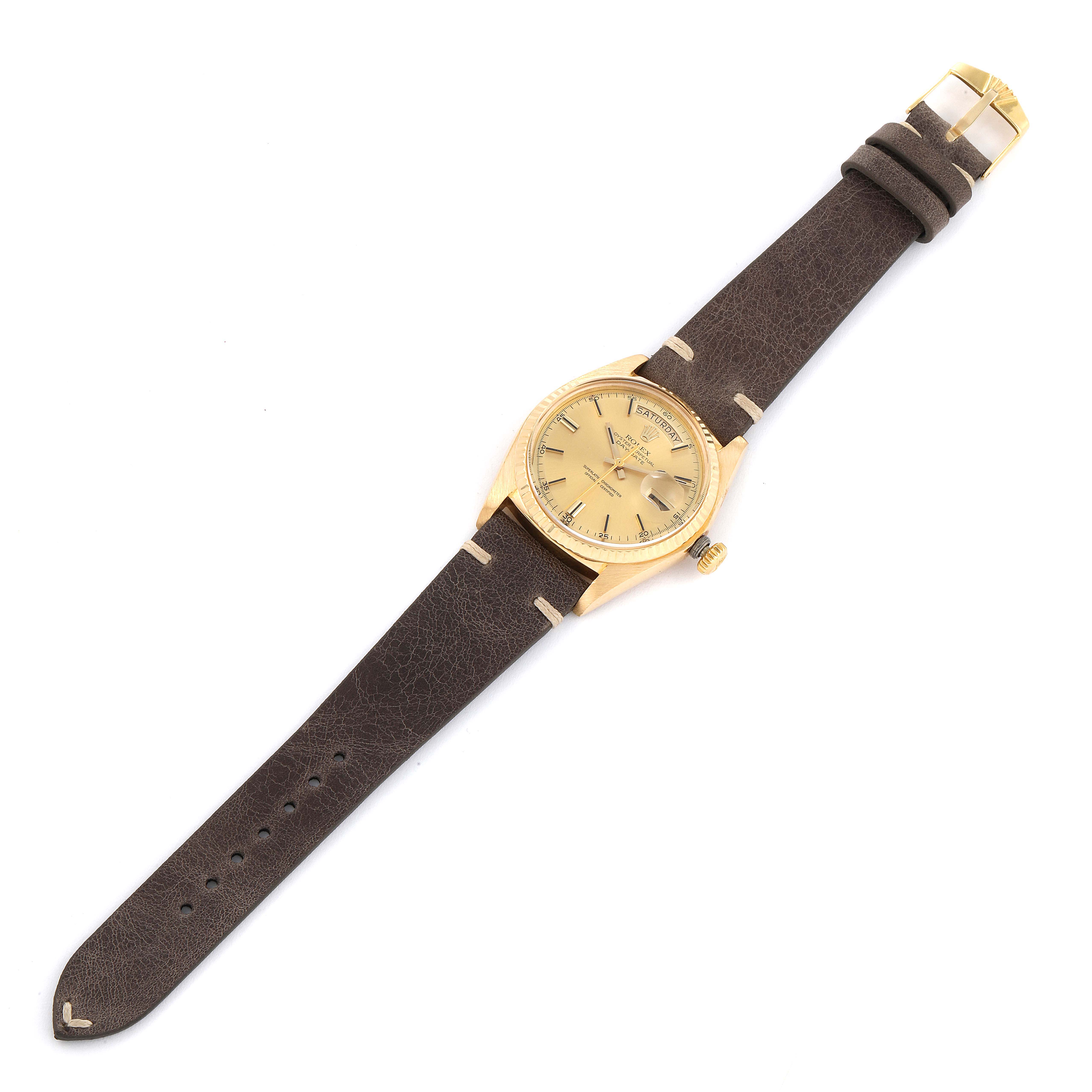 The image shows a Rolex President 1803 Men's Yellow Gold Champagne Dial 1803 Men's Yellow Gold Champagne Dial model watch from a top-down angle, displaying its face, leather strap, and buckle.