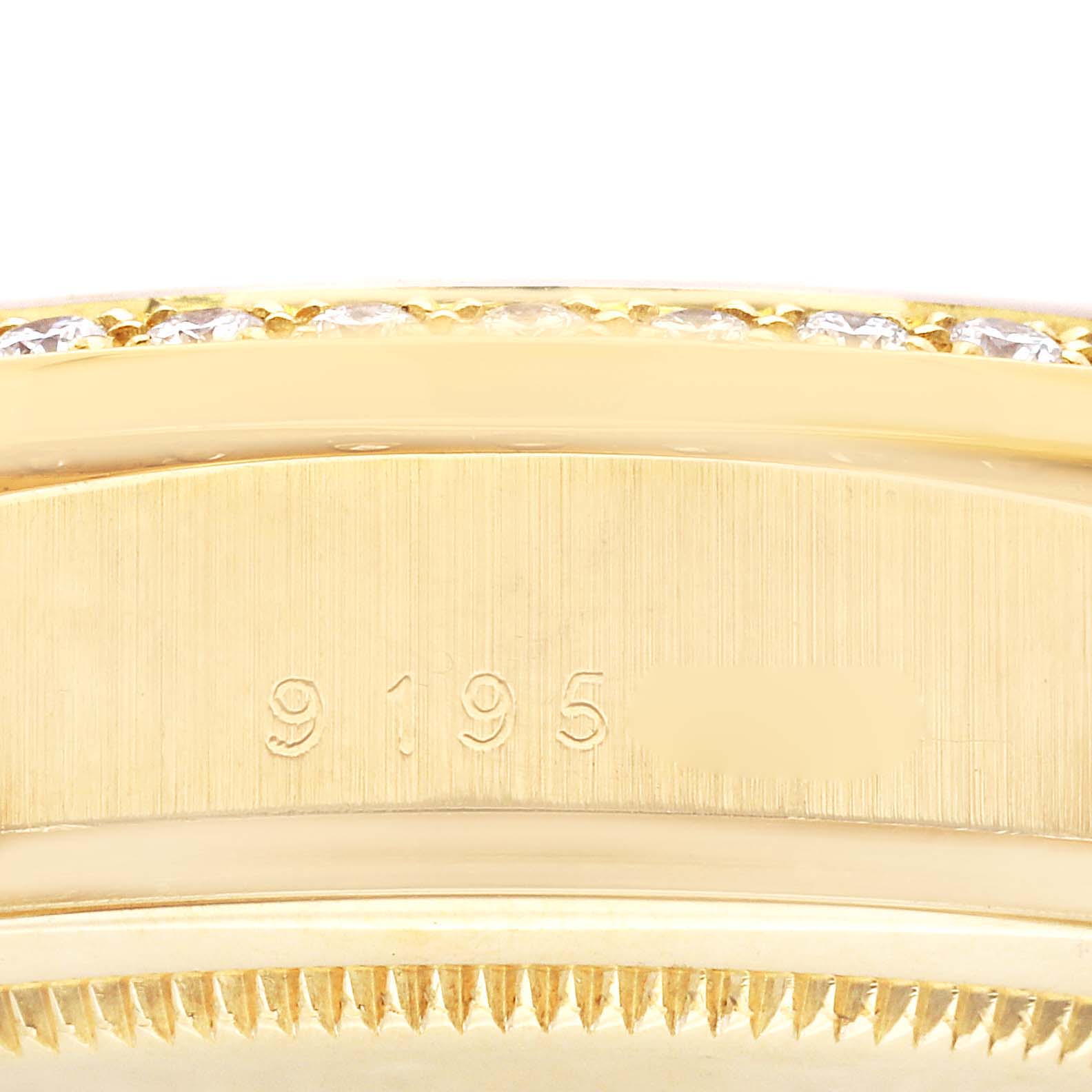 The image shows a close-up of the side of a Rolex President 18048A Men
s Yellow Gold Champagne Dial 18048A Men
s Yellow Gold Champagne Dial model, highlighting the serial number and part of the bezel.