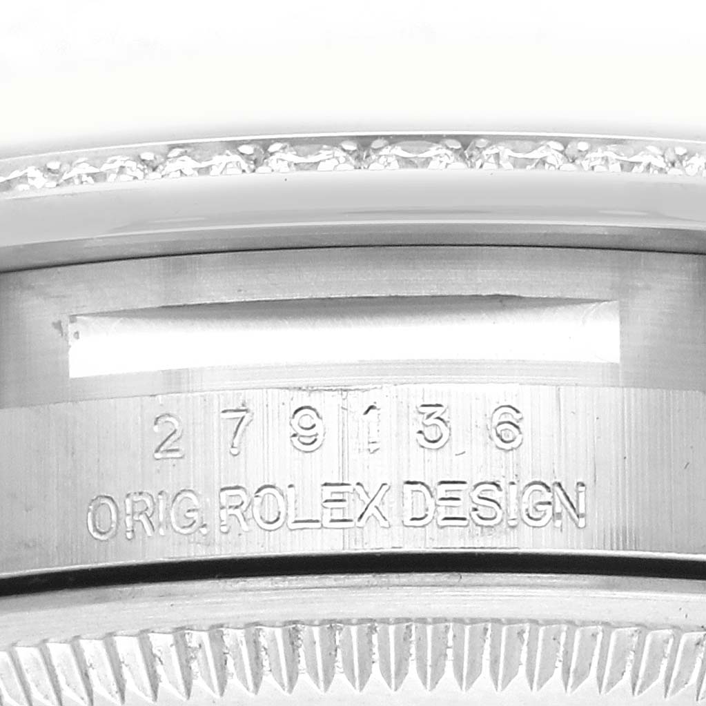 The image shows a close-up of the Rolex President 279136 Women's Platinum Blue Dial 279136 Women's Platinum Blue Dial model watch, featuring the engraved bezel and "ORIG ROLEX DESIGN" inscription.