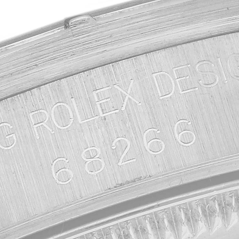 The image shows a close-up of the engraved outer rim and part of the bezel of a Rolex President 68266 Women
s Platinum Blue Dial 68266 Women
s Platinum Blue Dial model watch.