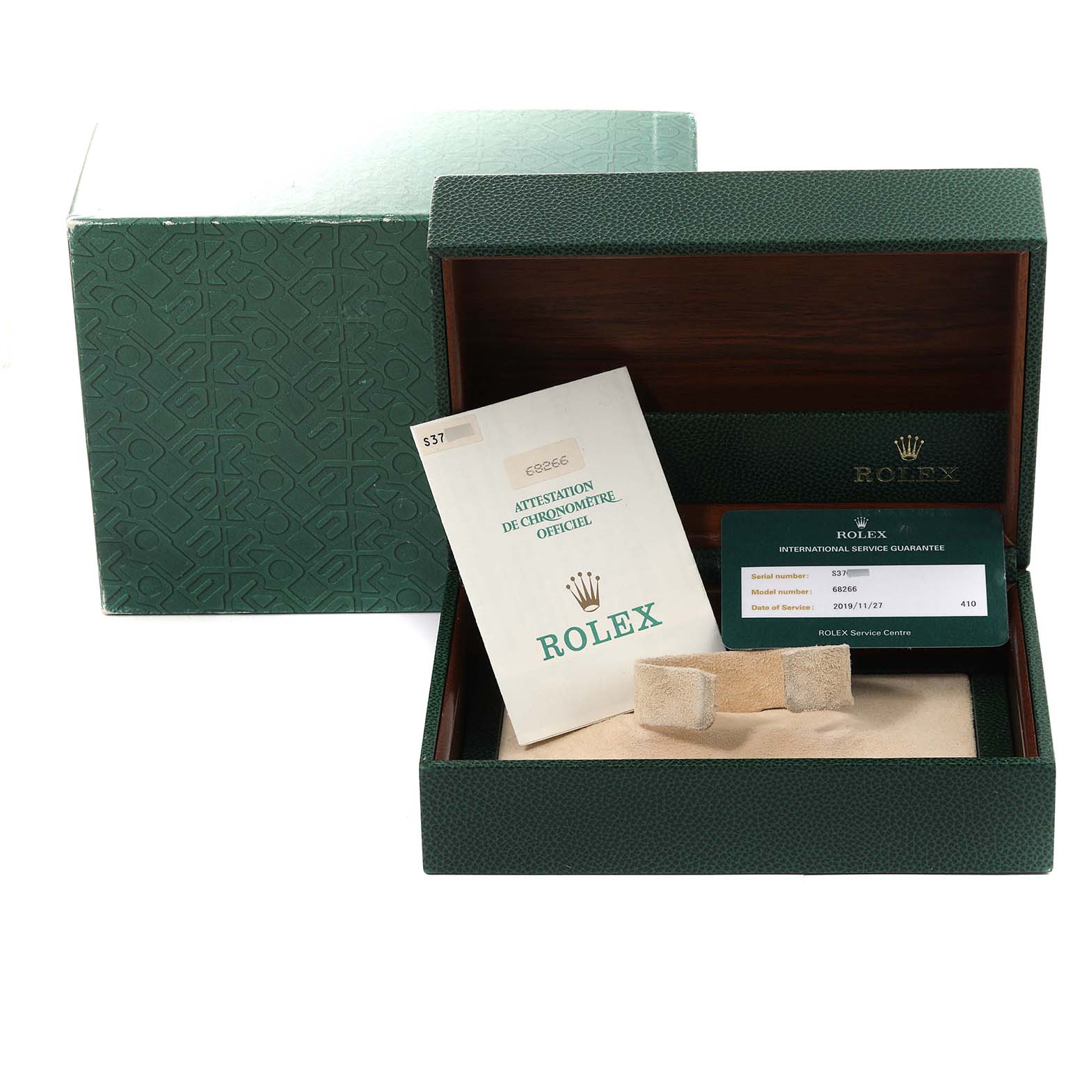 This image shows an open green Rolex box for the President model, with paperwork and a display pillow inside.