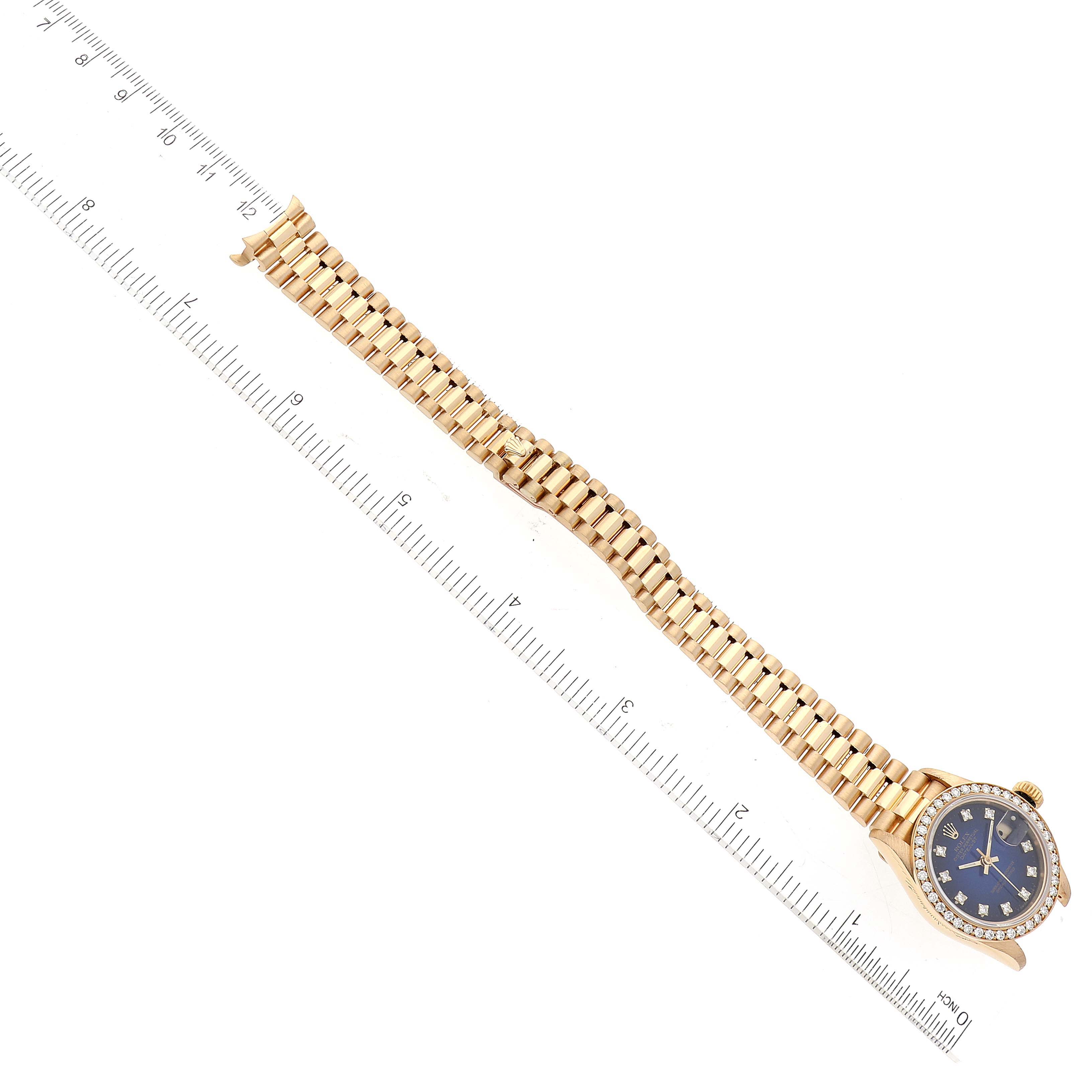 The image shows a Rolex President 69138 Women's Yellow Gold Blue Dial 69138 Women's Yellow Gold Blue Dial model watch laid out flat with a ruler beside it for size reference.