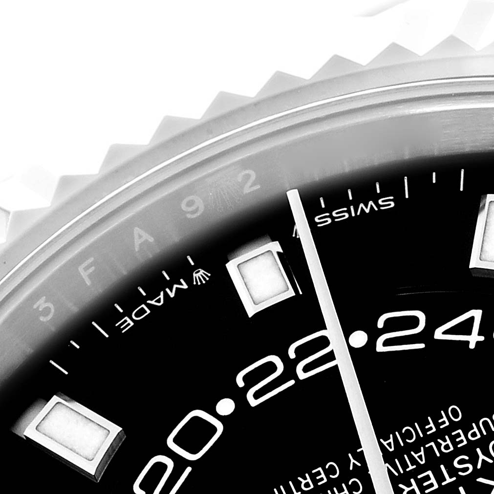 The image shows a close-up of the Rolex Sky-Dweller 336934 Men
s Stainless Steel Black Dial 336934 Men
s Stainless Steel Black Dial watch, focusing on the dial with hour markers and part of the fluted bezel.