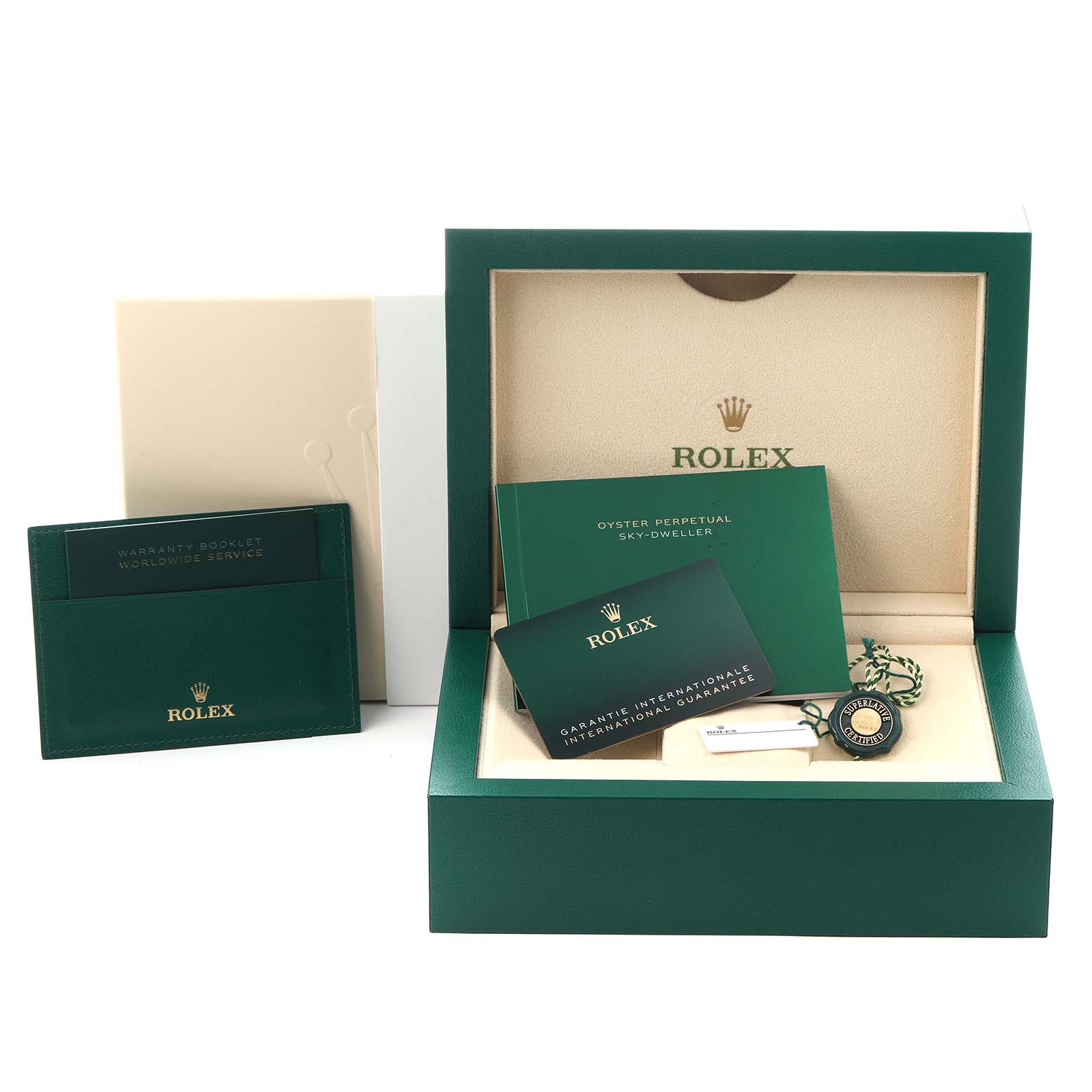 The image shows an open Rolex Sky-Dweller 336934 Men
s Stainless Steel Green Dial 336934 Men
s Stainless Steel Green Dial box with booklets, a warranty card, and a tag from a front angle.