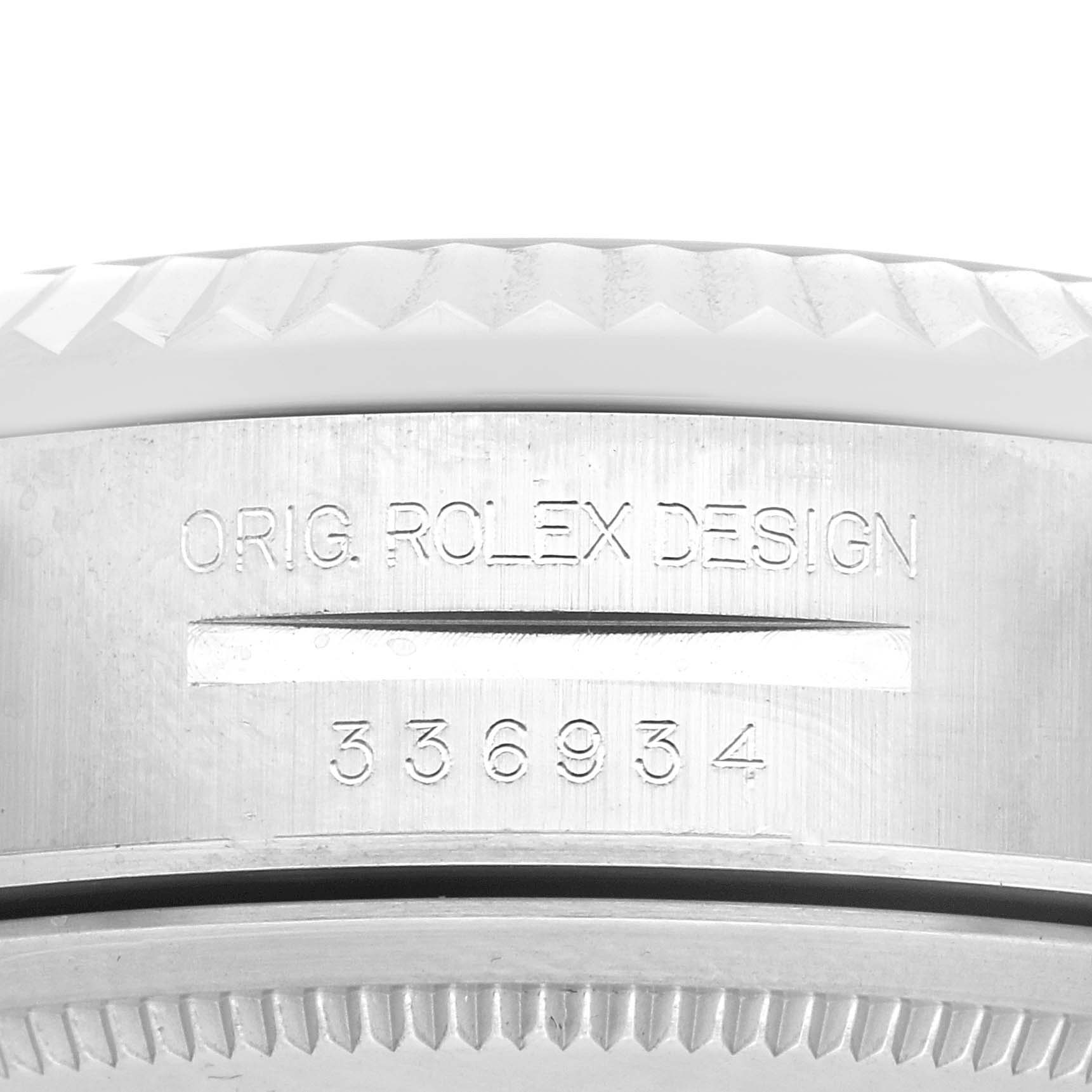 The image shows a close-up of the side of a Rolex Sky-Dweller 336934 Men
s Stainless Steel Green Dial 336934 Men
s Stainless Steel Green Dial
s case, highlighting etched serial numbers and text.