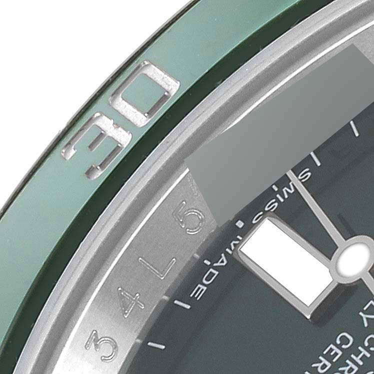 This close-up image shows the bezel, dial edge, and part of the minute hand of a Rolex Submariner 116610LV Men
s Stainless Steel Green Dial 116610LV Men
s Stainless Steel Green Dial watch.