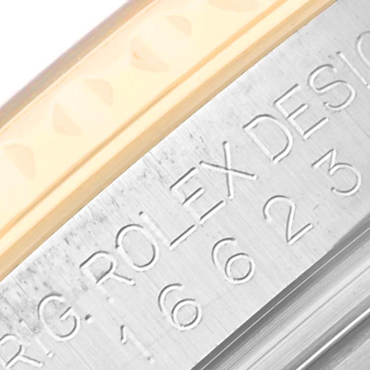This close-up image shows the engraved side of the bezel and case of a Rolex Yacht-Master 16623 Men's Steel and Gold (two tone) Champagne Dial 16623 Men's Steel and Gold (two tone) Champagne Dial watch.