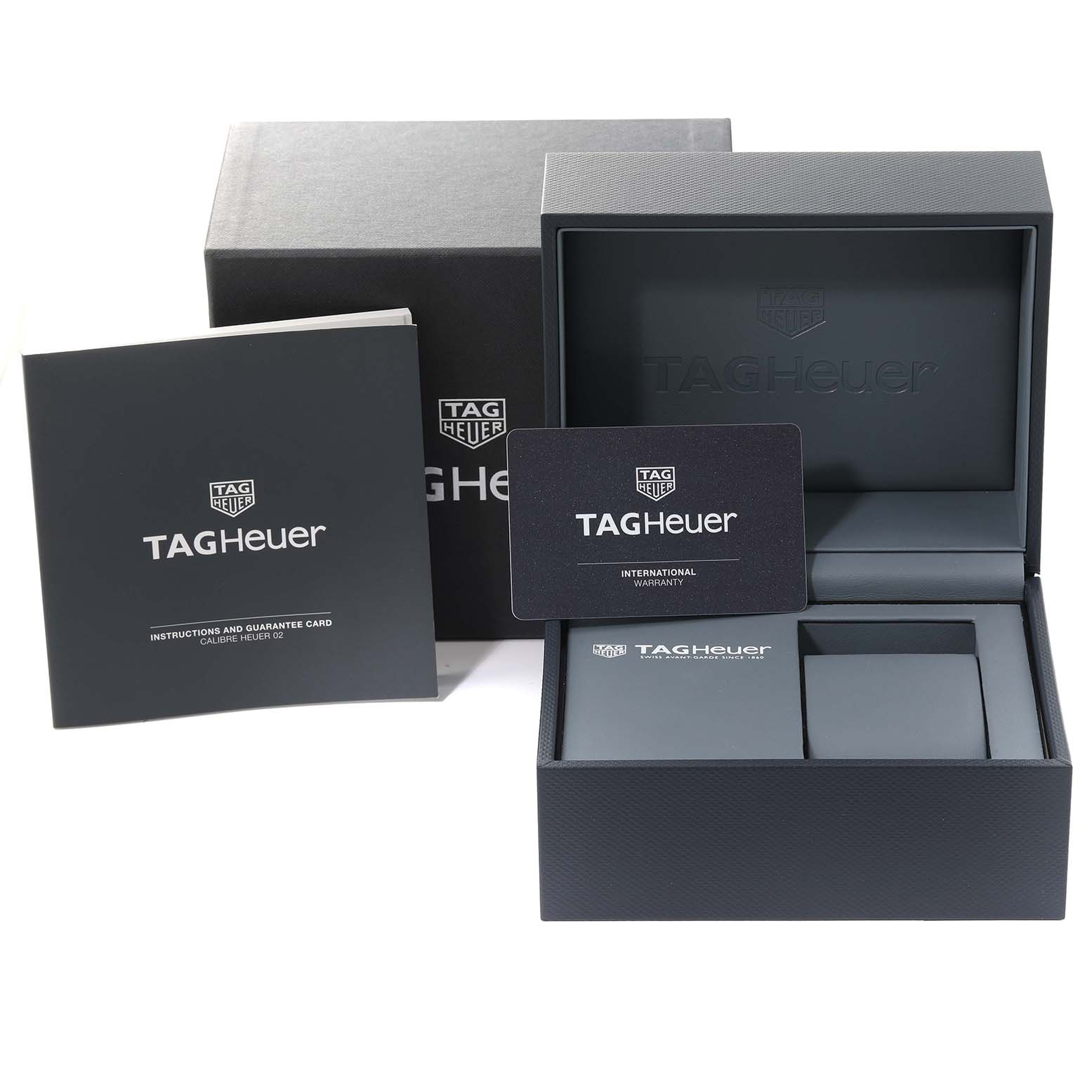 The image shows the Tag Heuer Monaco CBL2113.BA0644 Men
s Stainless Steel Black Dial CBL2113.BA0644 Men
s Stainless Steel Black Dial watch packaging, including the box, warranty card, and instruction manual.
