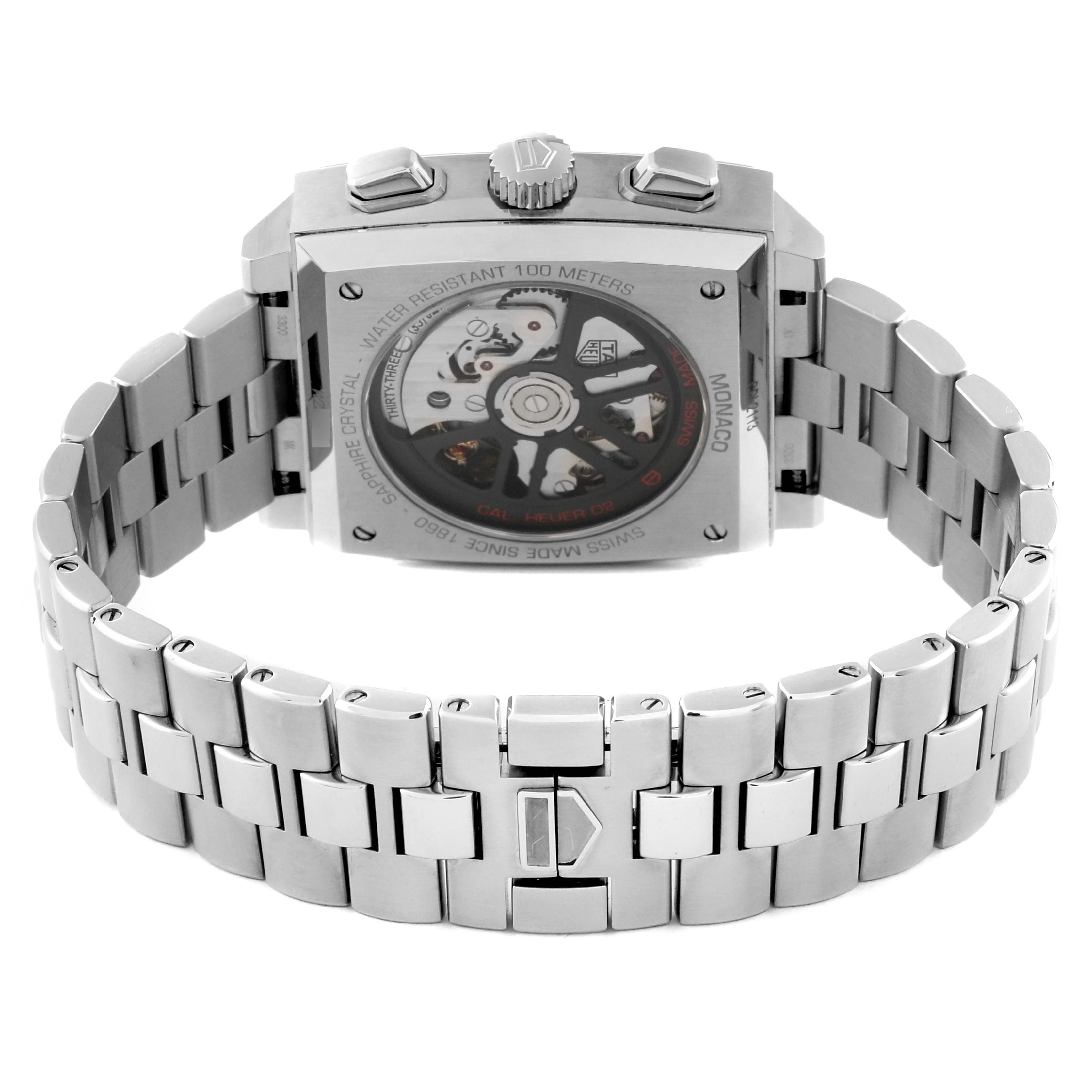 The image shows the back view of the Tag Heuer Monaco CBL2113.BA0644 Men
s Stainless Steel Black Dial CBL2113.BA0644 Men
s Stainless Steel Black Dial watch, highlighting its transparent case back and stainless steel bracelet.