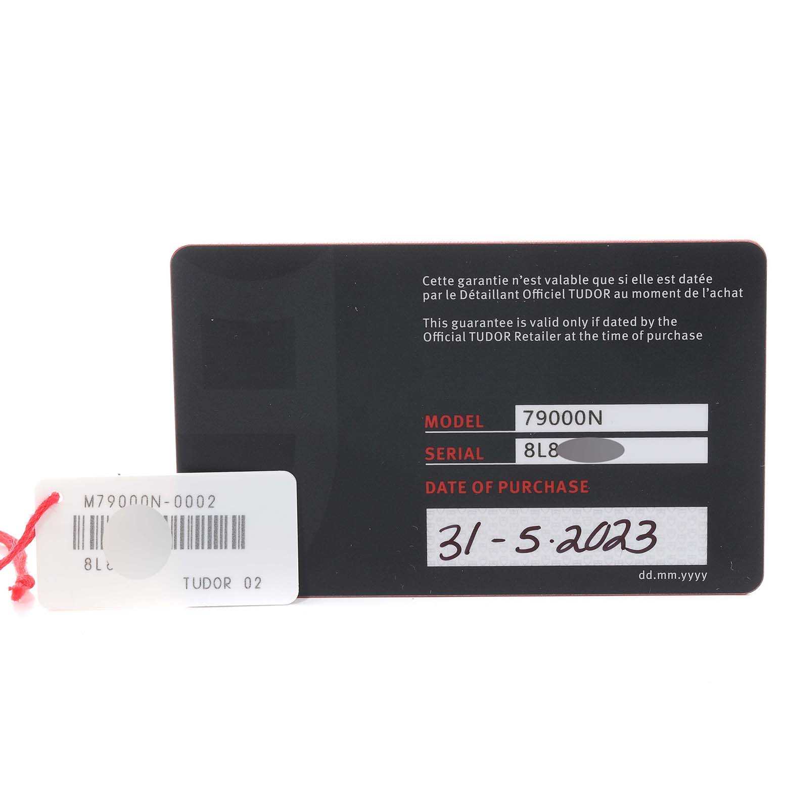 This image shows a warranty card stub for a Tudor Heritage Black Bay M79000N-0002 Men
s Stainless Steel Black Dial M79000N-0002 Men
s Stainless Steel Black Dial model 79000N, displaying the serial number and date of purchase.