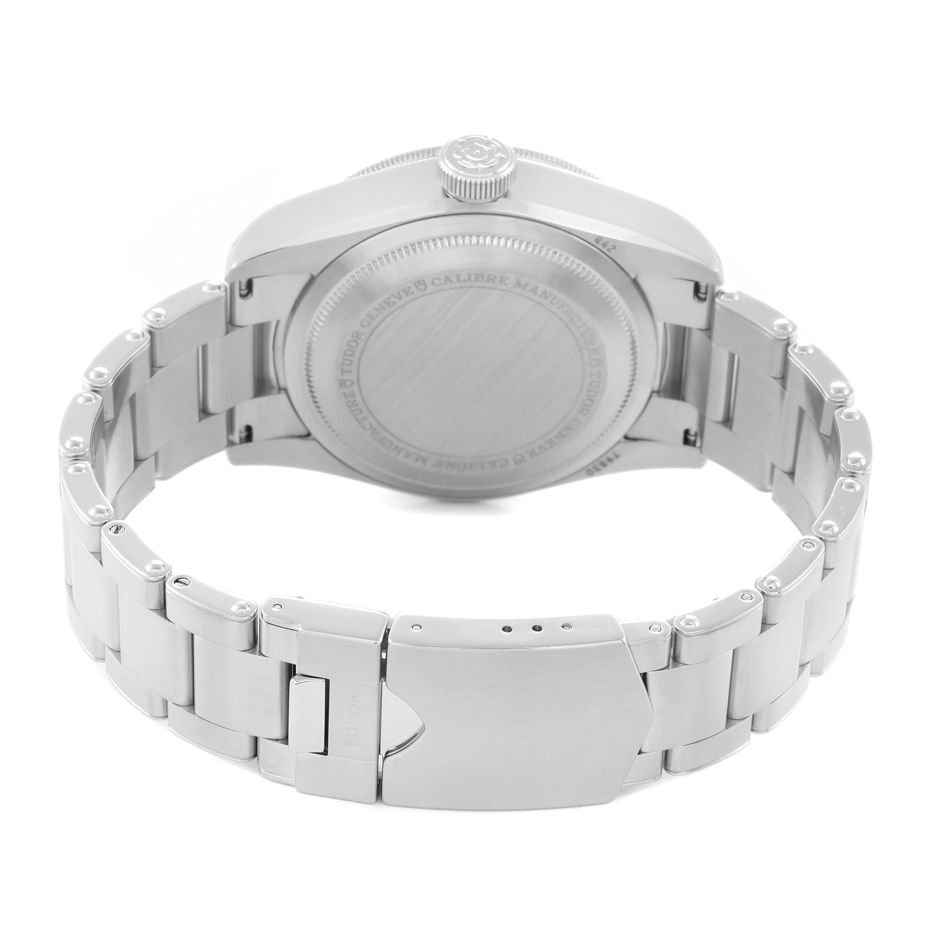 The image shows the Heritage Black Bay by Tudor from the back, highlighting the case back and stainless steel bracelet.