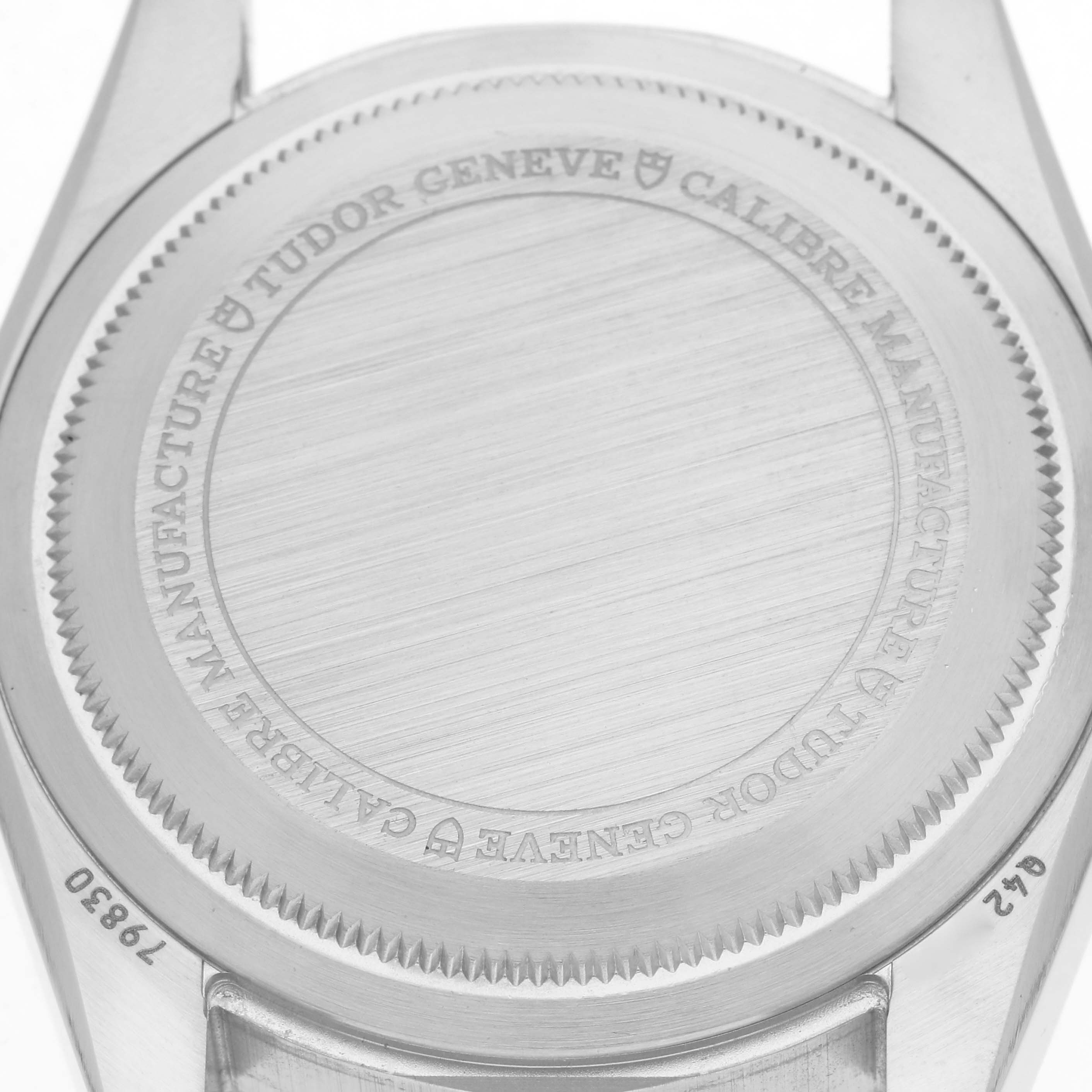 The image shows the case back of a Tudor Heritage Black Bay 79830RB Men
s Stainless Steel Black Dial 79830RB Men
s Stainless Steel Black Dial watch, engraved with model details and branding.