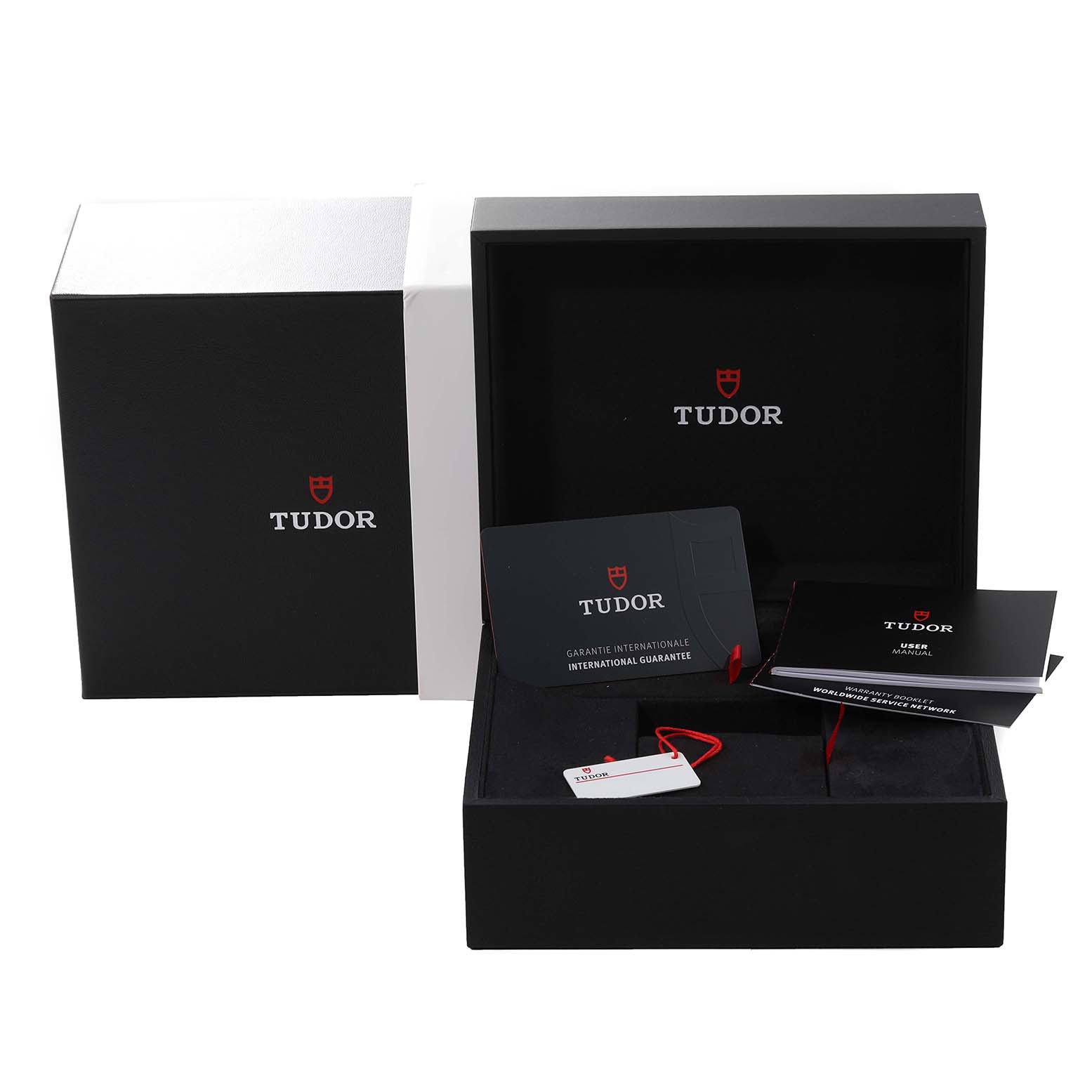 The image shows the packaging, warranty card, hang tag, and manuals of a Tudor Pelagos 2CWXXXX Men's Titanium Blue Dial 2CWXXXX Men's Titanium Blue Dial watch displayed from a front-angle view.