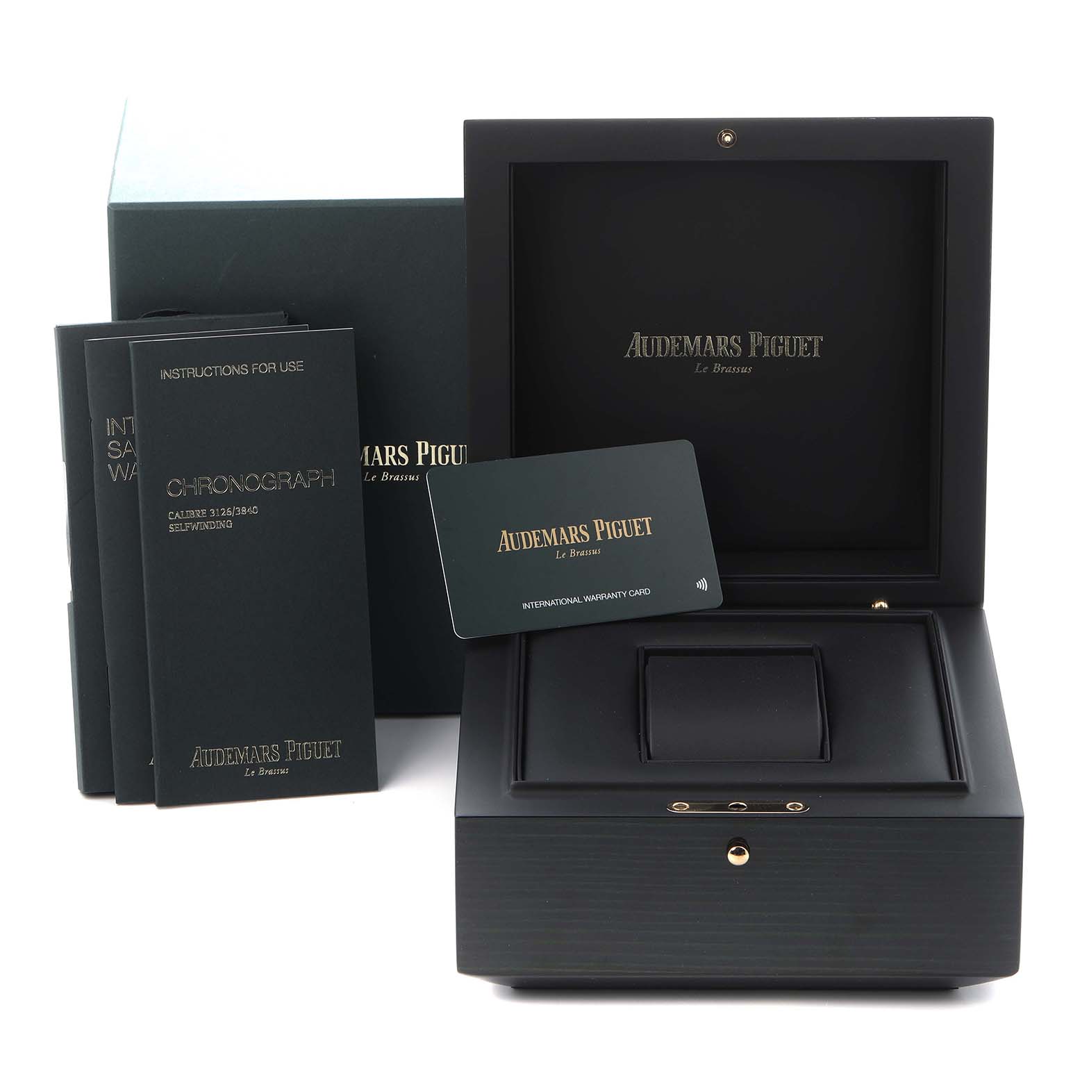 The image shows the packaging and accessories for an Audemars Piguet Royal Oak Offshore 26470IO.OO.A006CA.01 Men
s Titanium Grey Dial 26470IO.OO.A006CA.01 Men
s Titanium Grey Dial, including the box, warranty card, and manuals.