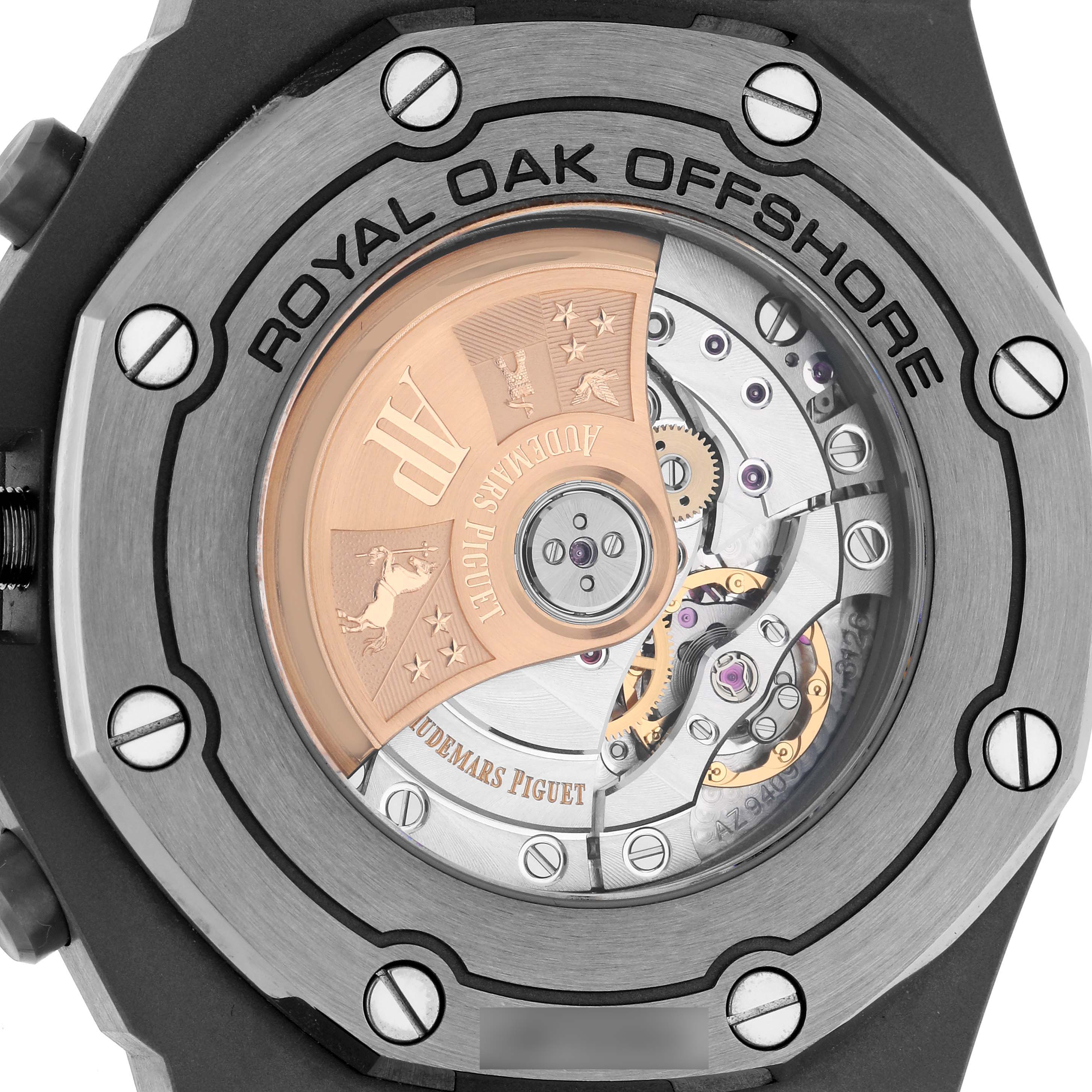 The image shows the back of the Audemars Piguet Royal Oak Offshore 26470IO.OO.A006CA.01 Men
s Titanium Grey Dial 26470IO.OO.A006CA.01 Men
s Titanium Grey Dial, highlighting its rotor and movement details.