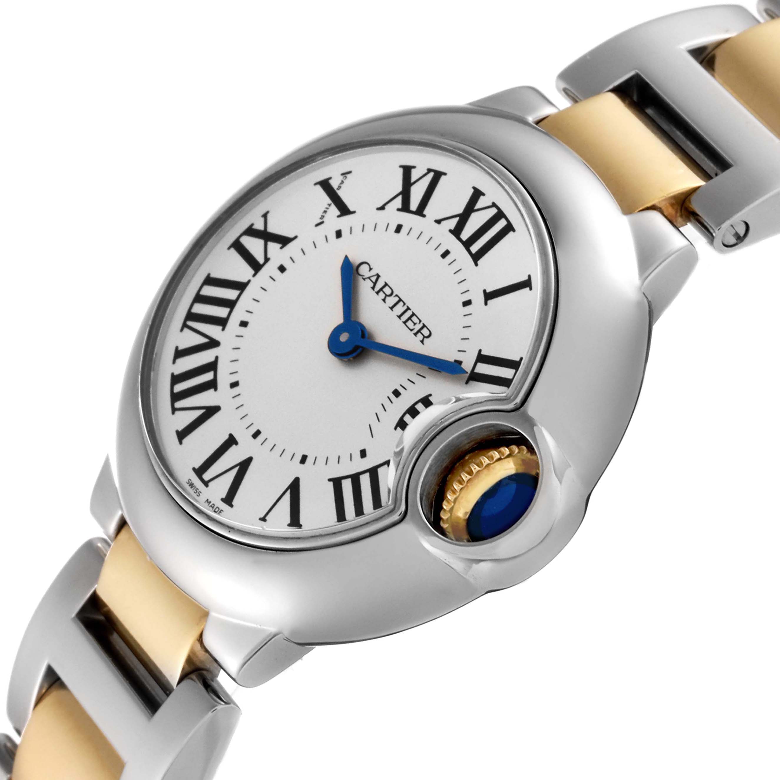 The image shows a close-up of the dial and crown of a Cartier Ballon Bleu W69007Z3 Women
s Steel and Gold (two tone) Silver Dial W69007Z3 Women
s Steel and Gold (two tone) Silver Dial watch at an angle.