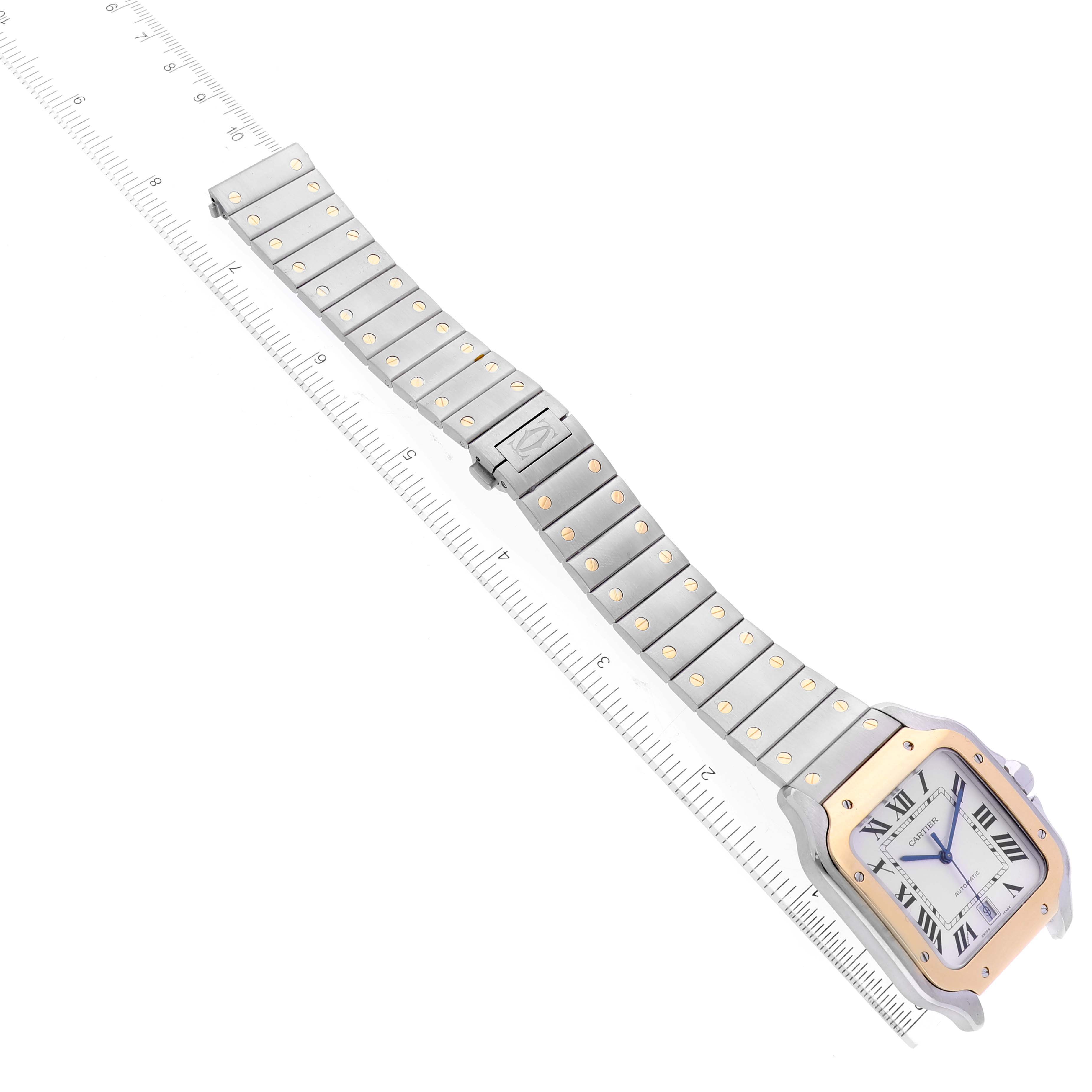 The Cartier Santos W2SA0009 Men
s Steel and Gold (two tone) Silver Dial W2SA0009 Men
s Steel and Gold (two tone) Silver Dial watch is shown from a top view, displaying the face, bezel, and metal bracelet with a ruler for scale.