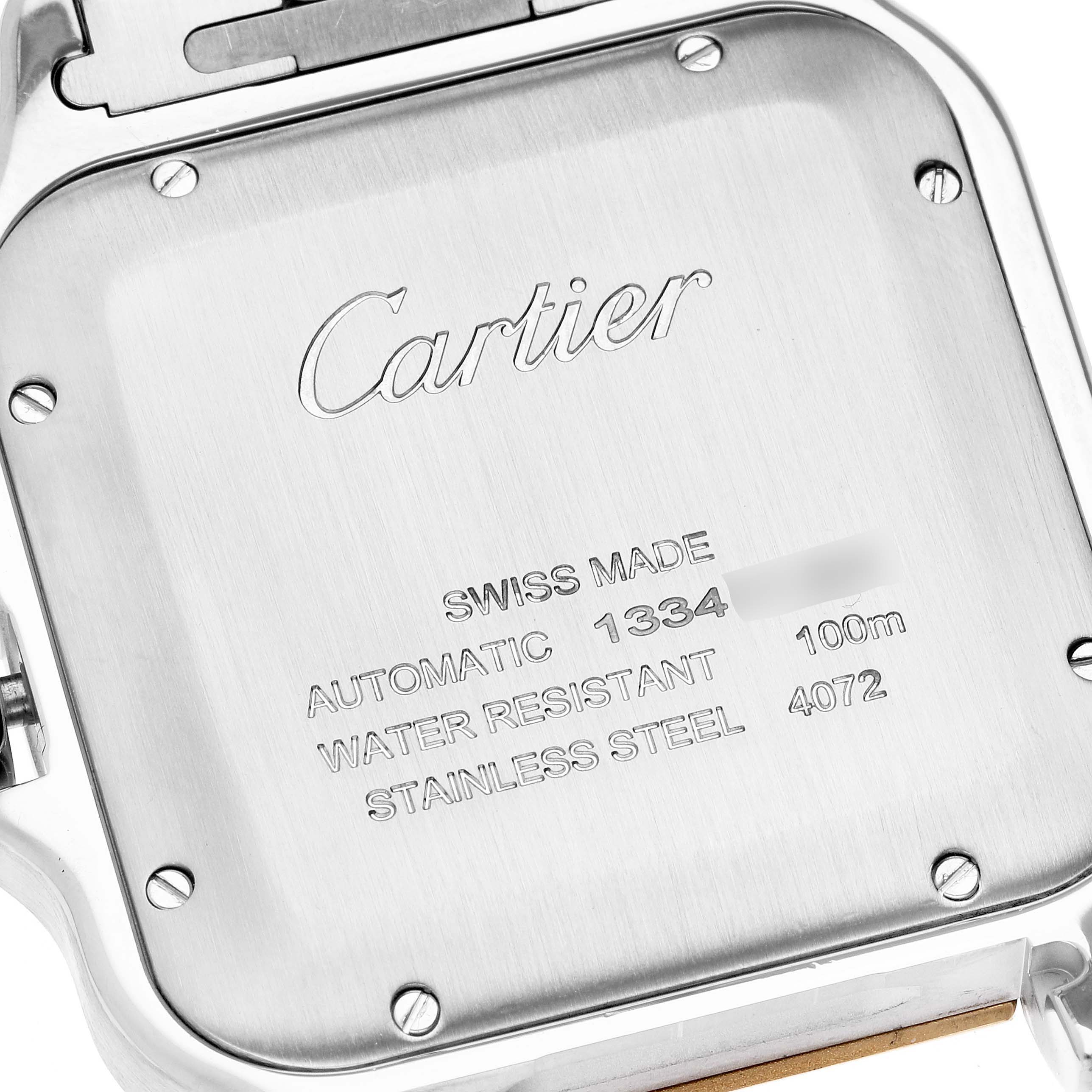 The image shows the back case of a Cartier Santos W2SA0009 Men
s Steel and Gold (two tone) Silver Dial W2SA0009 Men
s Steel and Gold (two tone) Silver Dial watch, highlighting its engravings and screws.