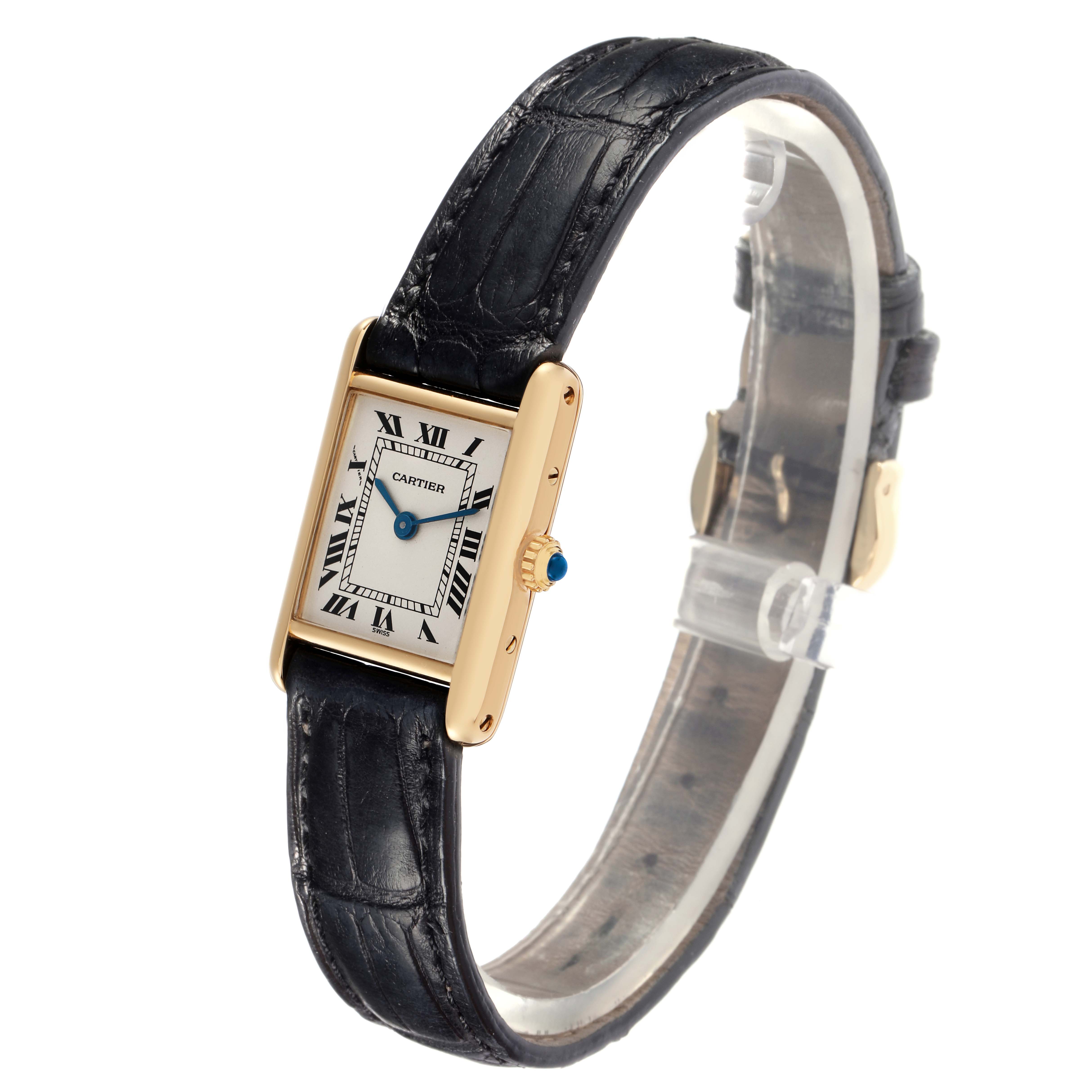 The Cartier Tank Classic 1150 Women
s Yellow Gold Silver Dial 1150 Women
s Yellow Gold Silver Dial watch is shown at an angle displaying the face, case, crown, and black leather strap.
