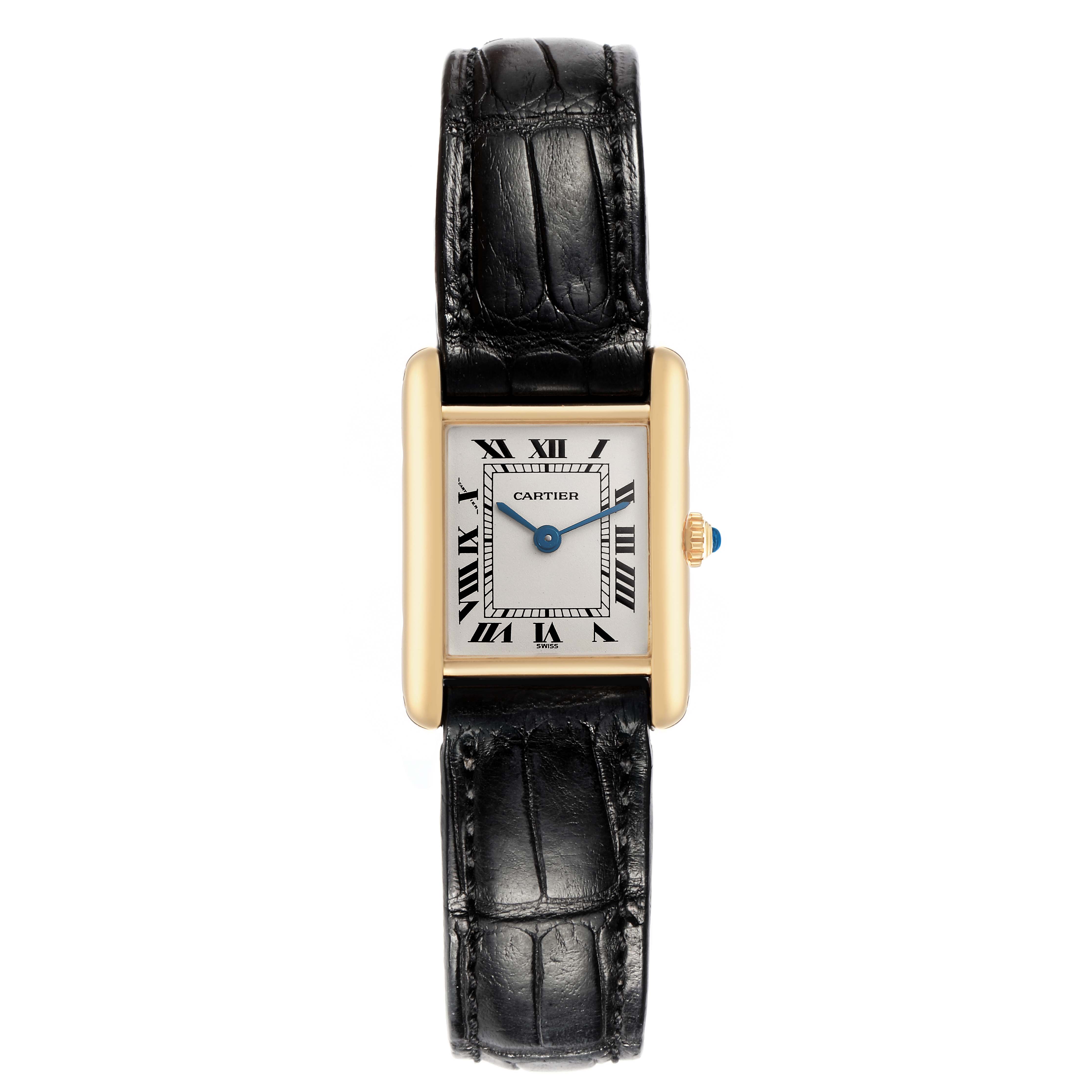 The Cartier Tank Classic 1150 Women
s Yellow Gold Silver Dial 1150 Women
s Yellow Gold Silver Dial watch is shown from a top view, displaying its rectangular face, gold case, and black leather strap.