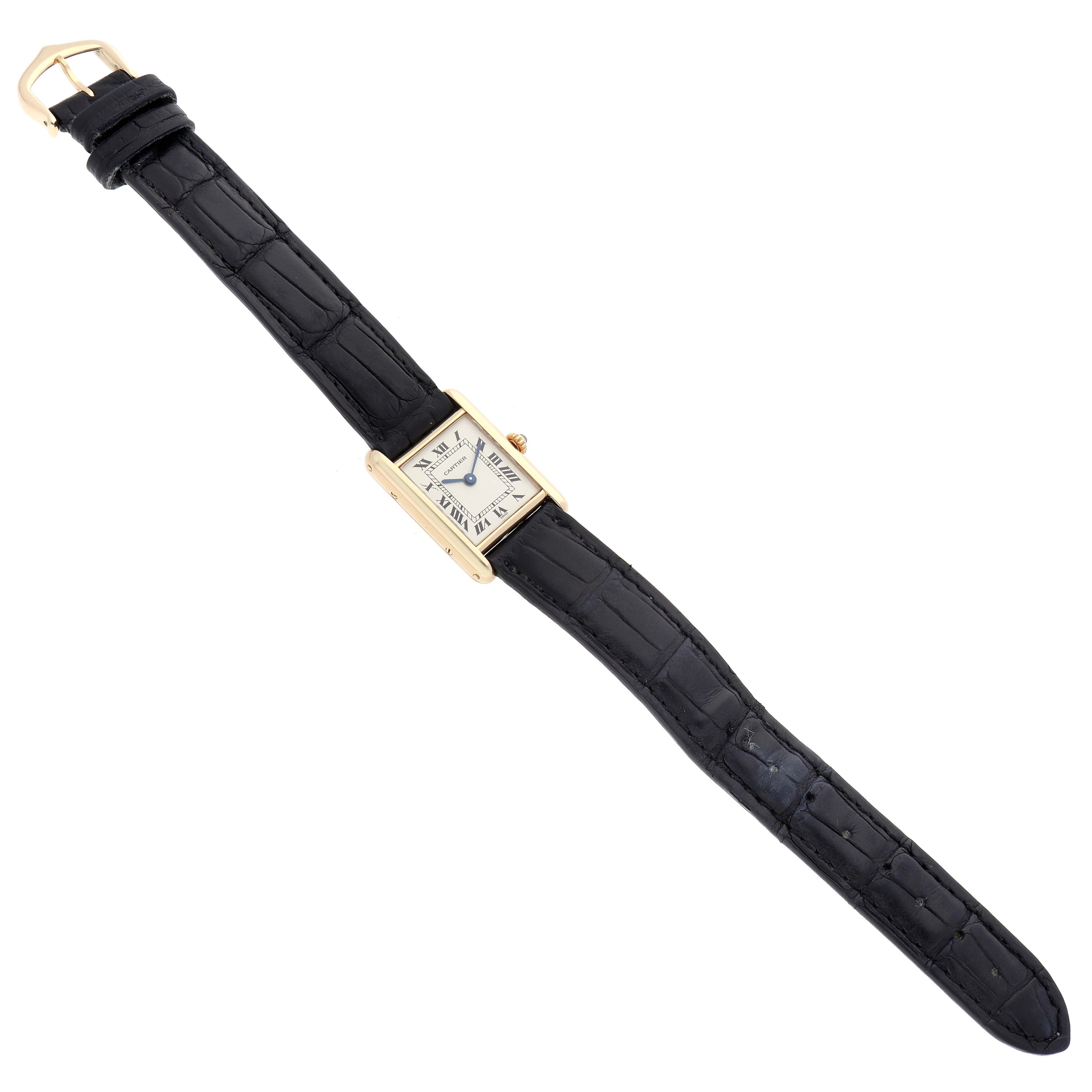 The Cartier Tank Classic 1150 Women
s Yellow Gold Silver Dial 1150 Women
s Yellow Gold Silver Dial watch is shown from a top-down angle, highlighting the strap, case, and dial.