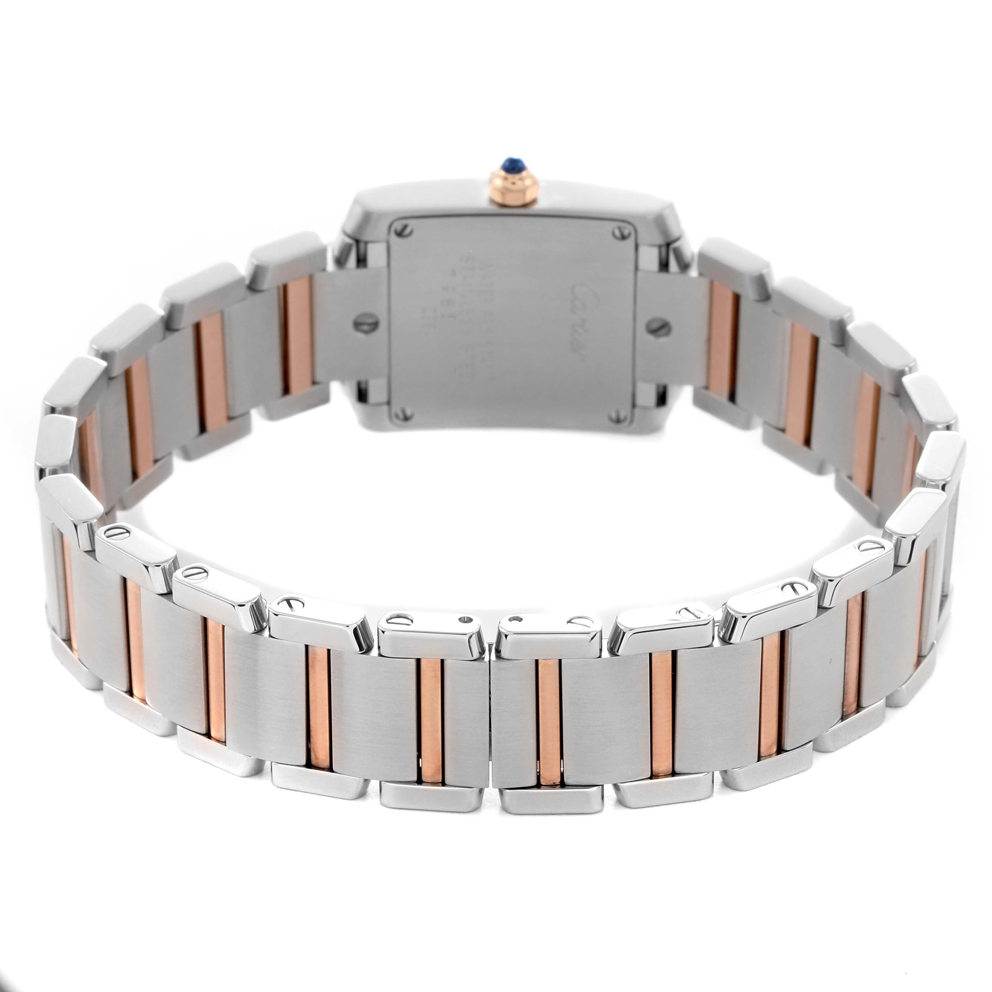 The Cartier Tank Française watch is shown from the back, highlighting its two-tone metal bracelet and case back.