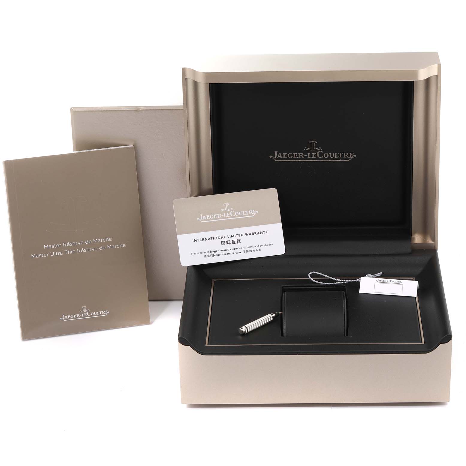 The image displays the packaging, manuals, international limited warranty, and accessories for a Jaeger-LeCoultre Master model watch.