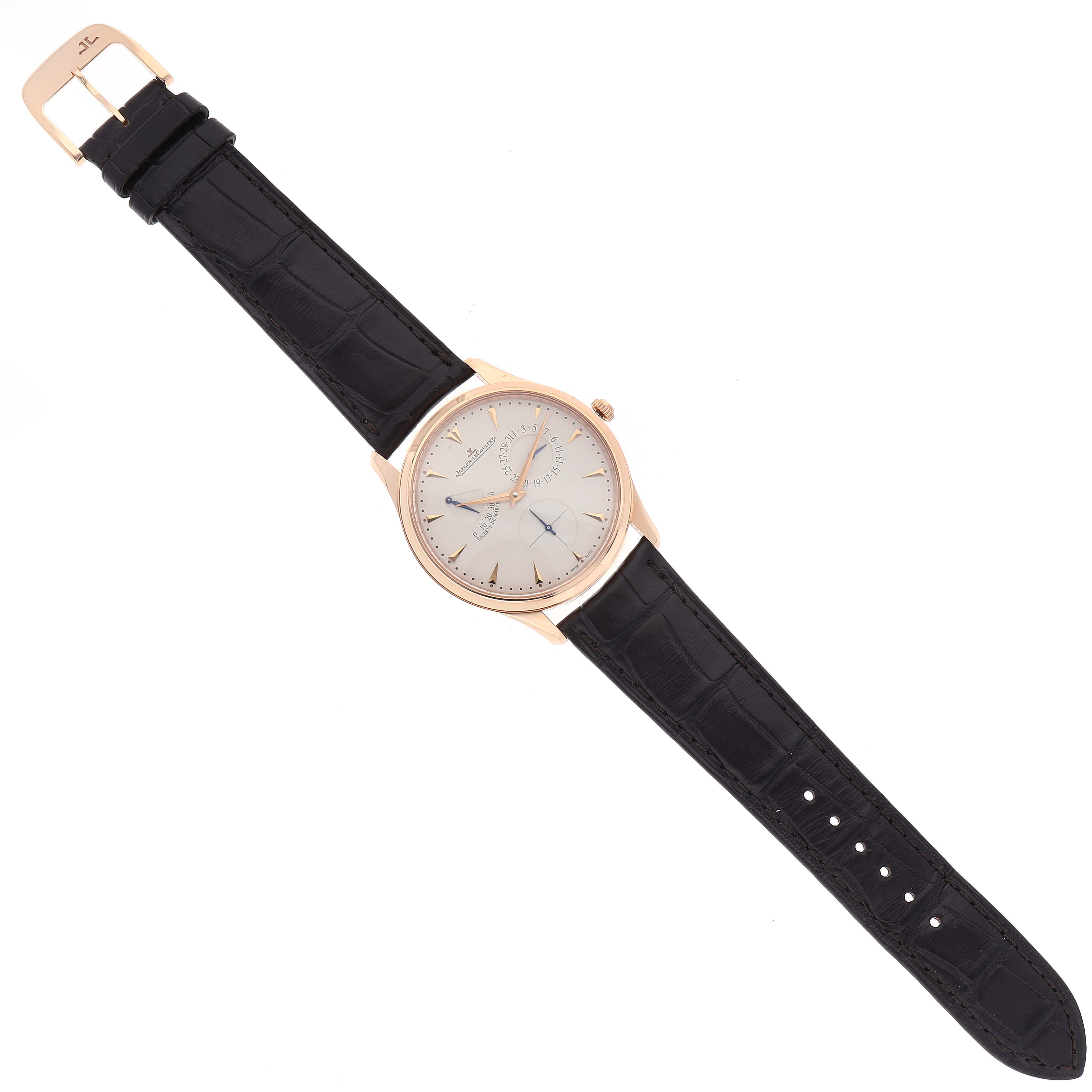 The image displays a Jaeger-LeCoultre Master model watch from a top-down angle, showcasing its dial, strap, and buckle.