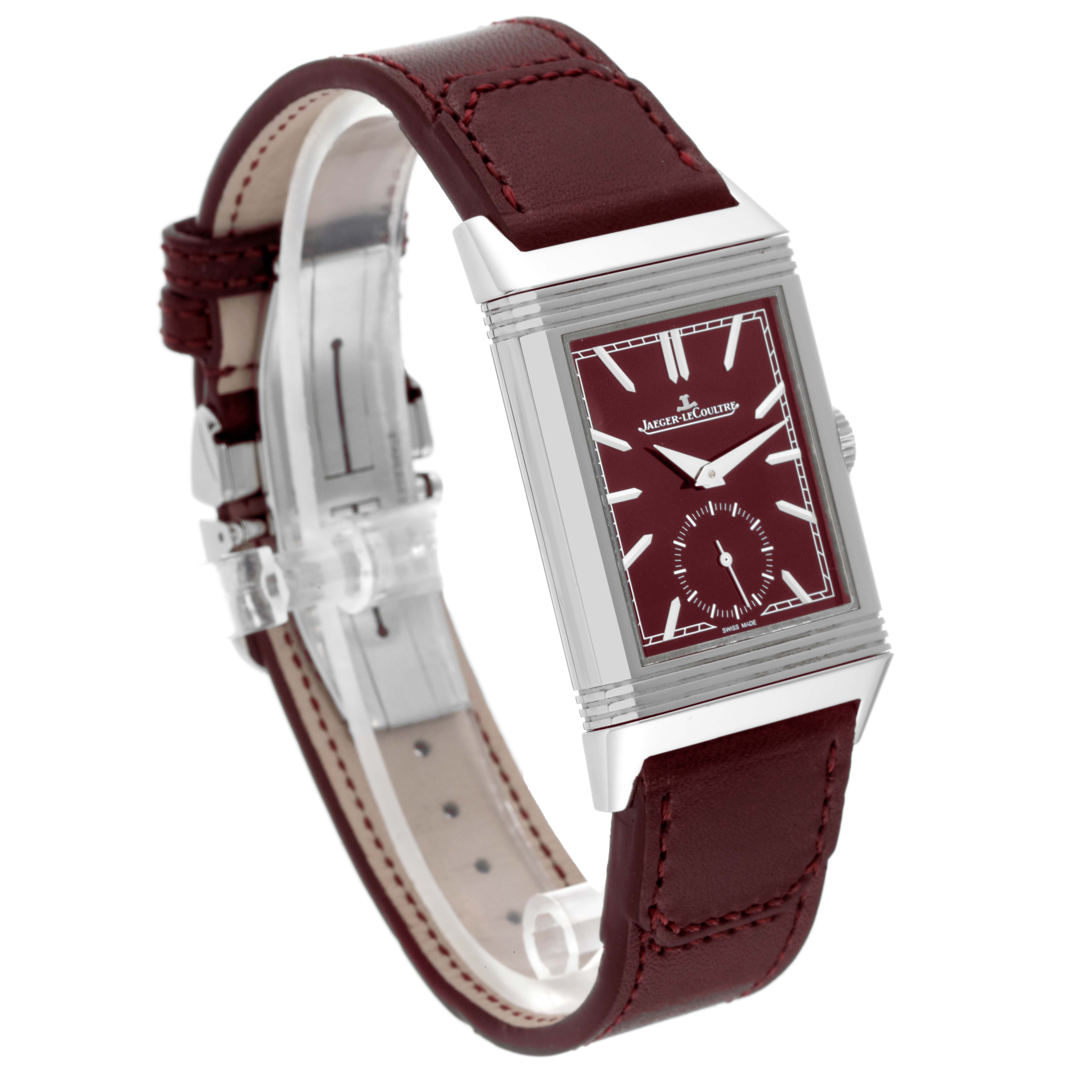 The image shows a Jaeger LeCoultre Reverso Q397846J Men's Stainless Steel Red Dial Q397846J Men's Stainless Steel Red Dial watch at a tilted angle, featuring a rectangular face with a burgundy strap.