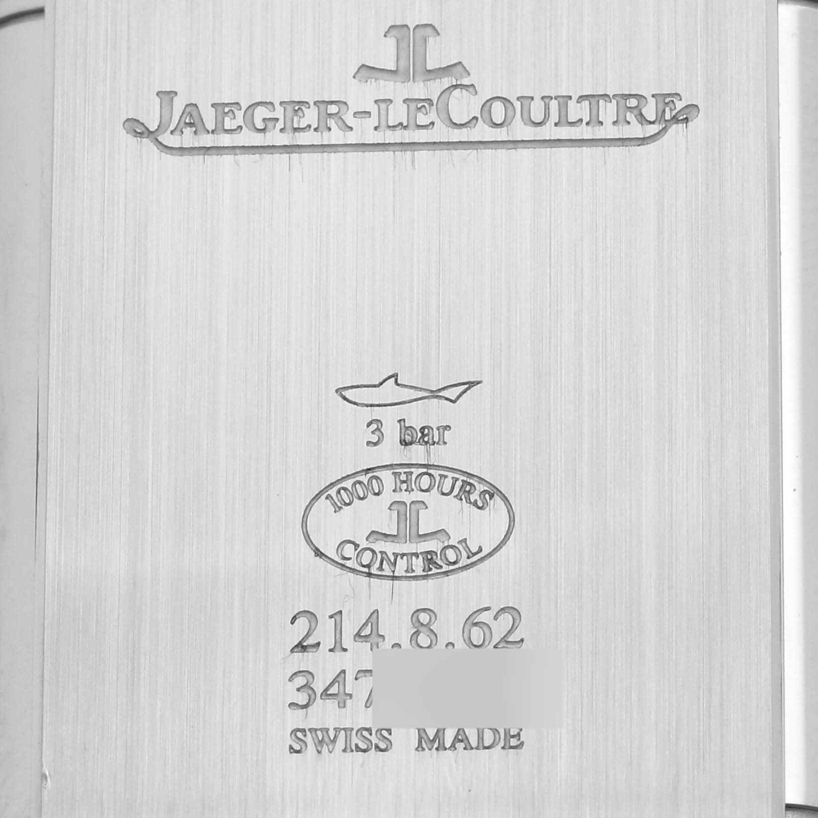 This image shows the back case of a Jaeger-LeCoultre Reverso watch with brand engravings and specifications.