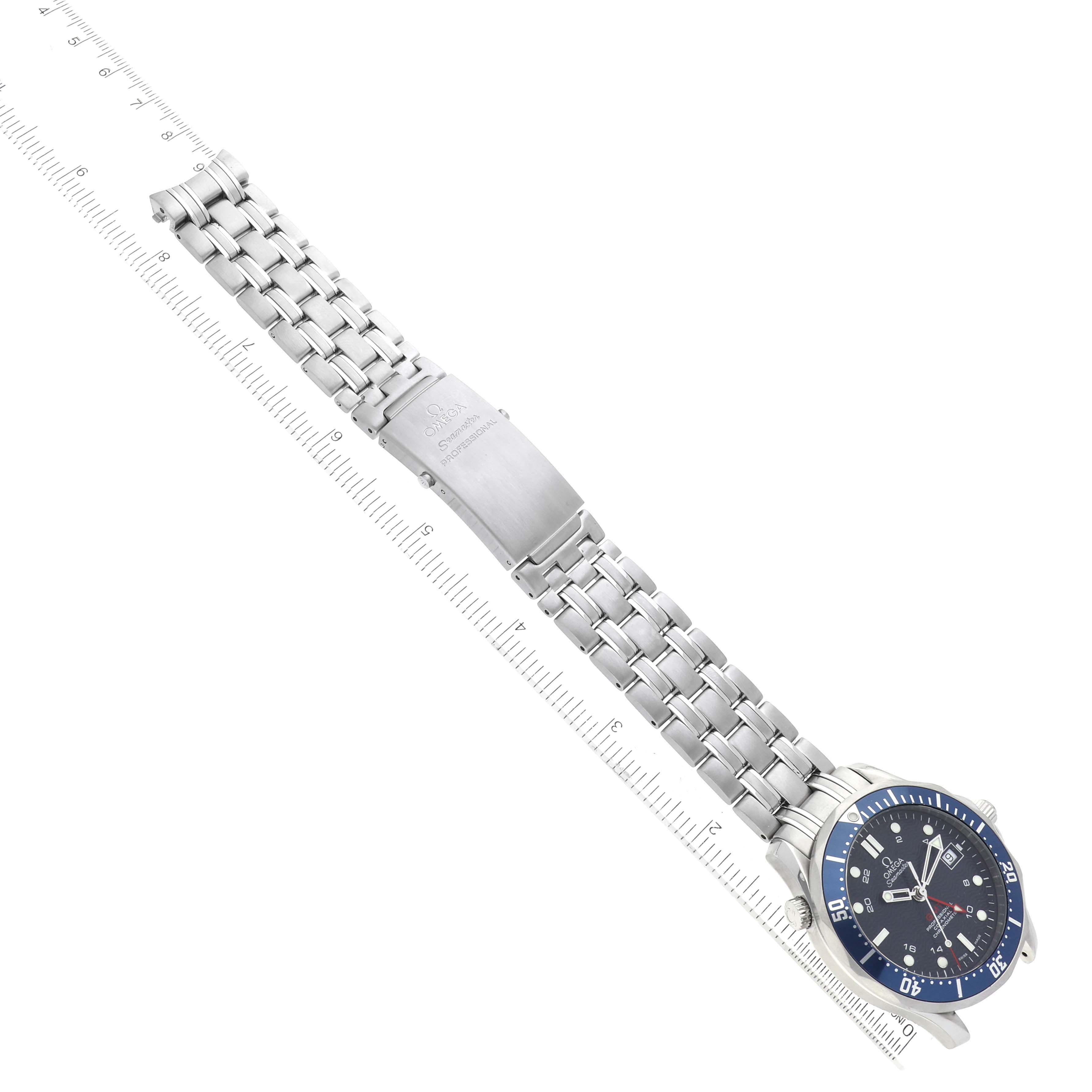 The Omega Seamaster 2535.80.00 Men
s Stainless Steel Blue Dial 2535.80.00 Men
s Stainless Steel Blue Dial watch is shown flat with a full view of the face, band, and clasp along a measuring ruler.