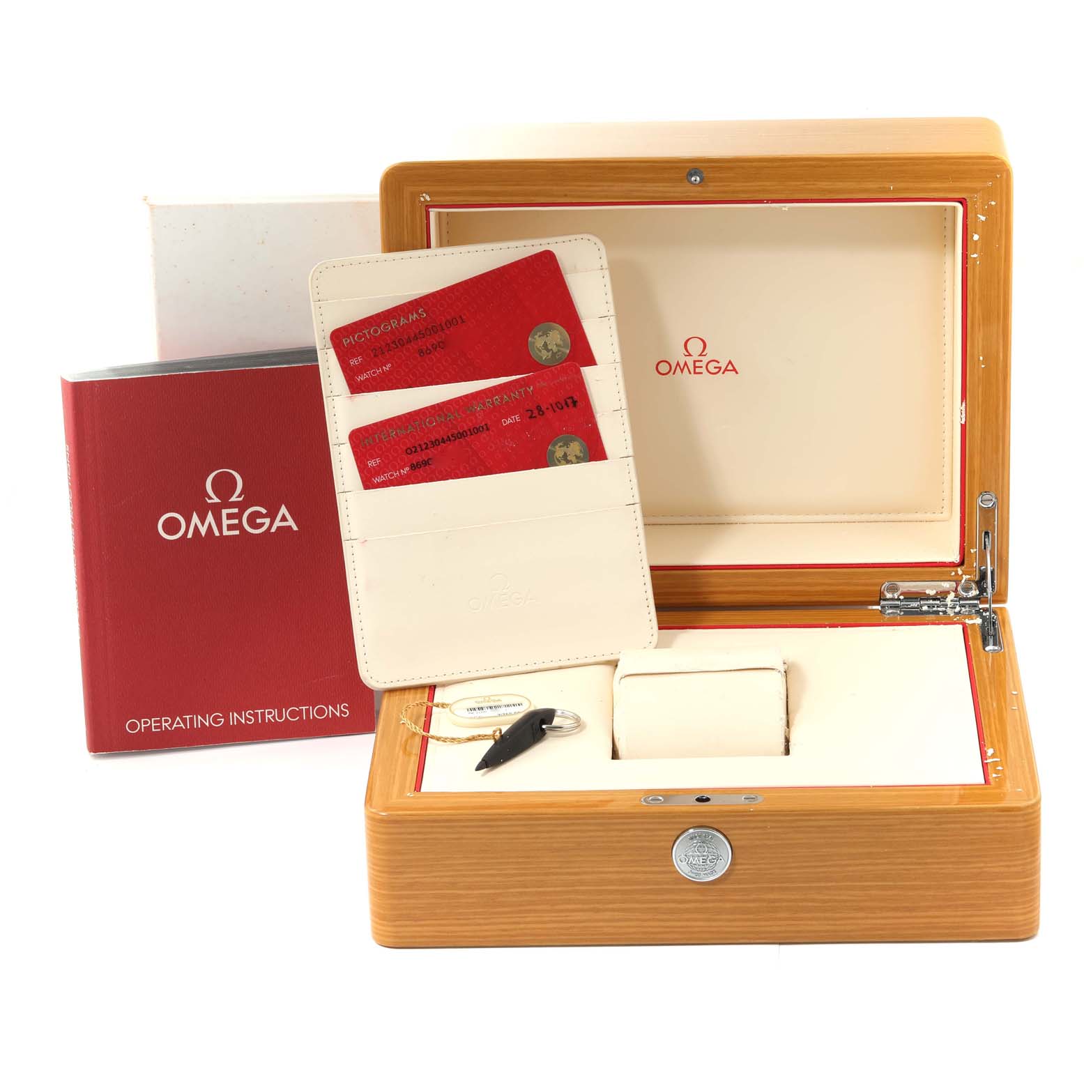 This image shows the open box of an Omega Seamaster 212.30.44.50.01.001 Men's Stainless Steel Black Dial 212.30.44.50.01.001 Men's Stainless Steel Black Dial watch, with its operating instructions, warranty cards, and a key.
