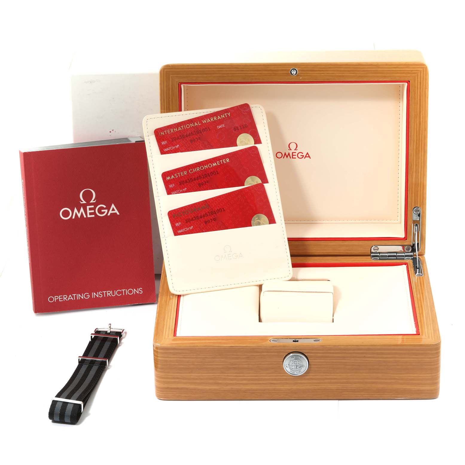 The image shows an Omega Speedmaster 304.30.44.52.01.001 Men
s Stainless Steel Black Dial 304.30.44.52.01.001 Men
s Stainless Steel Black Dial box, operating instructions, credit card wallets, and an additional strap.