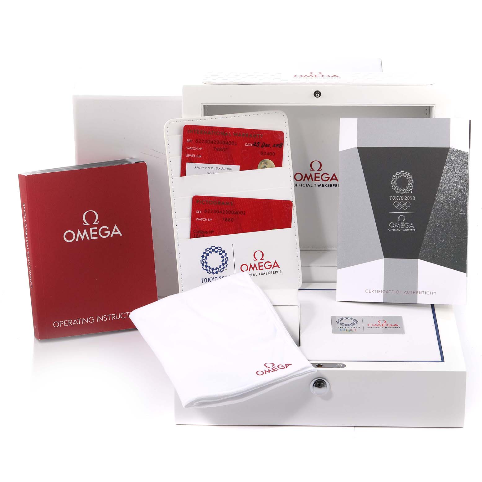 This image displays the accessories for an Omega Speedmaster 522.30.42.30.04.001 Men's Stainless Steel White Dial 522.30.42.30.04.001 Men's Stainless Steel White Dial, including the operating manual, certificate, cards, cloth, and box.