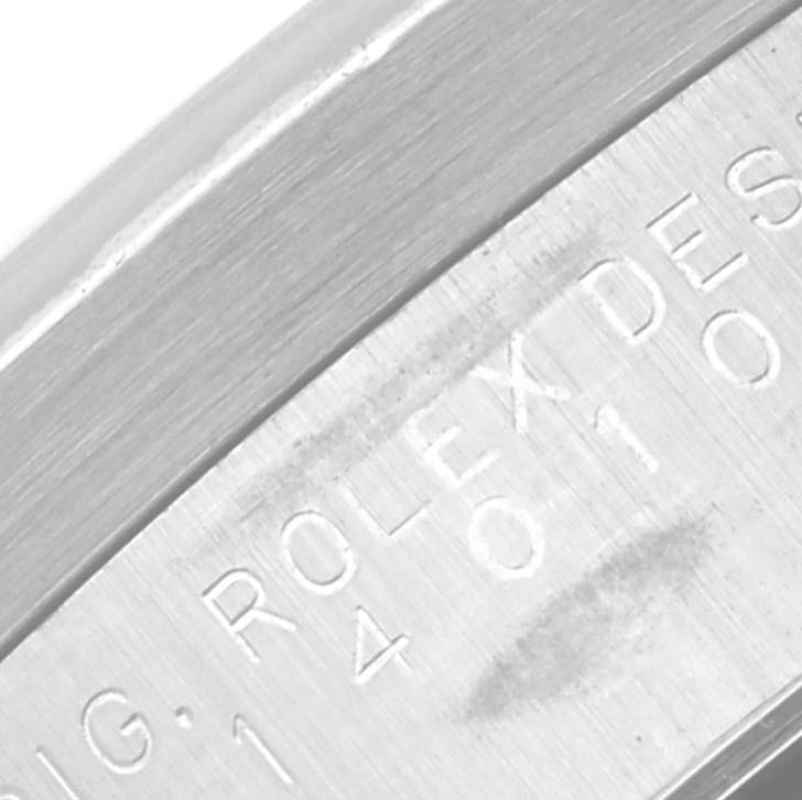 This close-up image shows the side engraving of an Air-King model by Rolex, displaying part of the serial number.