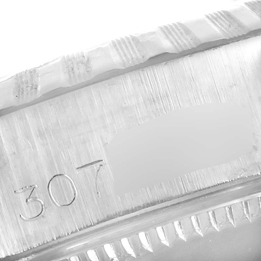 This image shows a close-up of the case side and possibly part of the bezel of a Rolex Date 6924 Women's Stainless Steel Silver Dial 6924 Women's Stainless Steel Silver Dial watch, including its serial number.