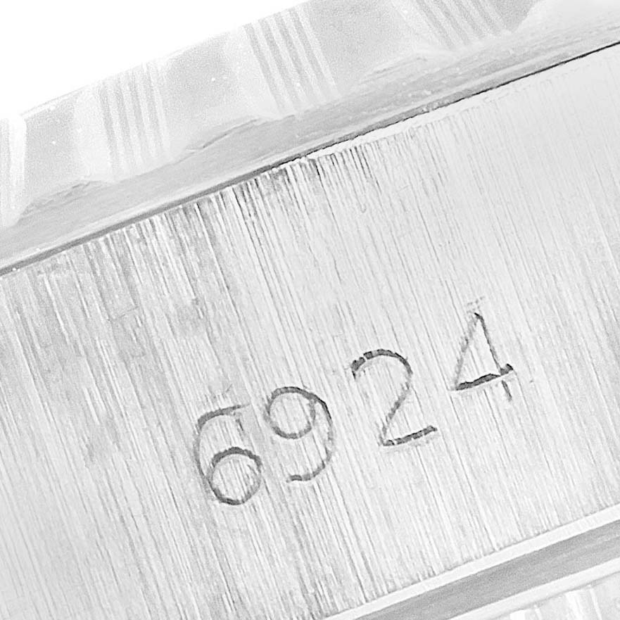 This image shows a close-up of the engraved serial number on the side of a Rolex Date 6924 Women's Stainless Steel Silver Dial 6924 Women's Stainless Steel Silver Dial model watch case.