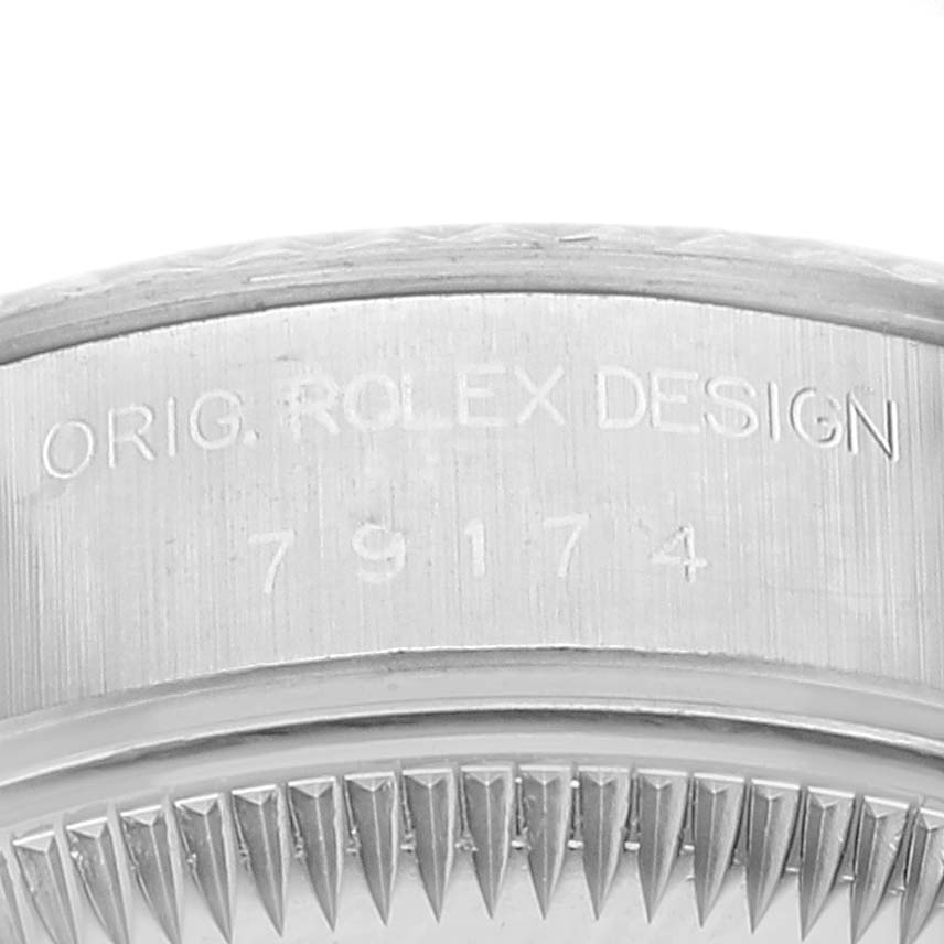 This image shows a close-up angle of the side engraving and bezel teeth of a Rolex Datejust 79174 Women's Stainless Steel Silver Dial 79174 Women's Stainless Steel Silver Dial watch.