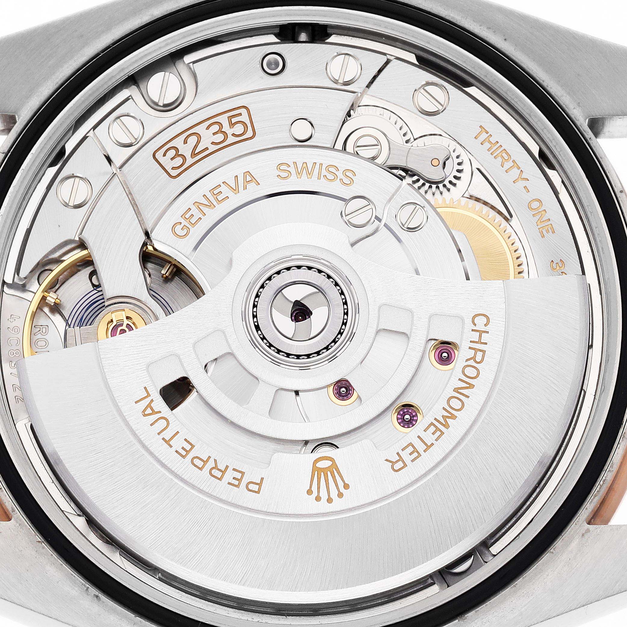 This image shows the Rolex Datejust 126231 Men
s Steel and Gold (two tone) Grey Dial 126231 Men
s Steel and Gold (two tone) Grey Dial
s inner movement mechanism, featuring the rotor, gears, and intricate engravings.