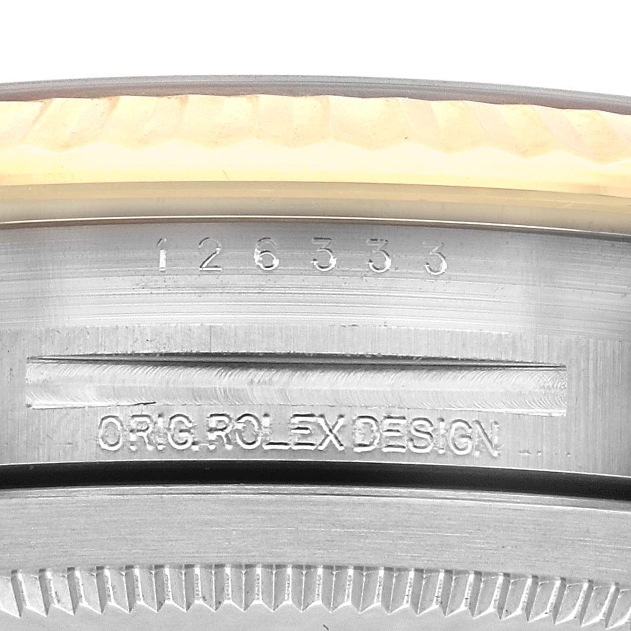 This image shows a close-up of the engraved case side of a Rolex Datejust 41 126333 Men's Steel and Gold (two tone) Grey Dial 126333 Men's Steel and Gold (two tone) Grey Dial, highlighting the model number and Rolex design inscription.