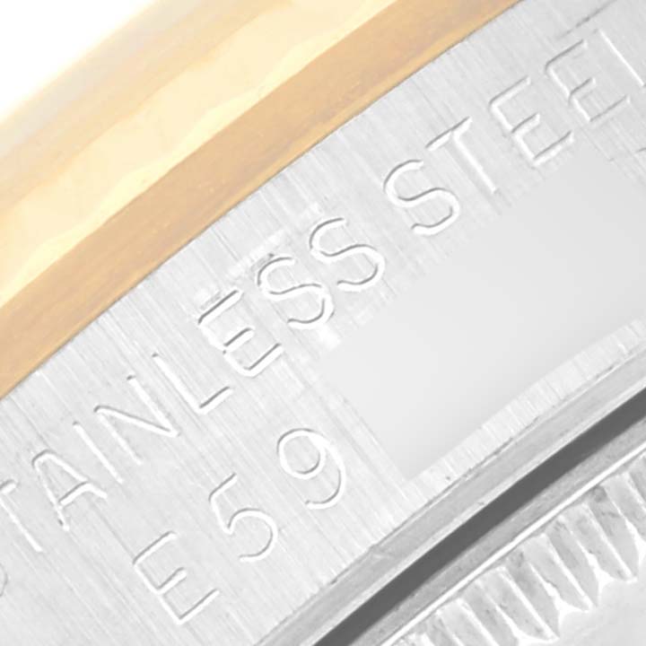 This close-up image shows the engraved stainless steel part of the bezel of a Rolex Mid-Size 68273 Women's Steel and Gold (two tone) White Dial 68273 Women's Steel and Gold (two tone) White Dial model watch.